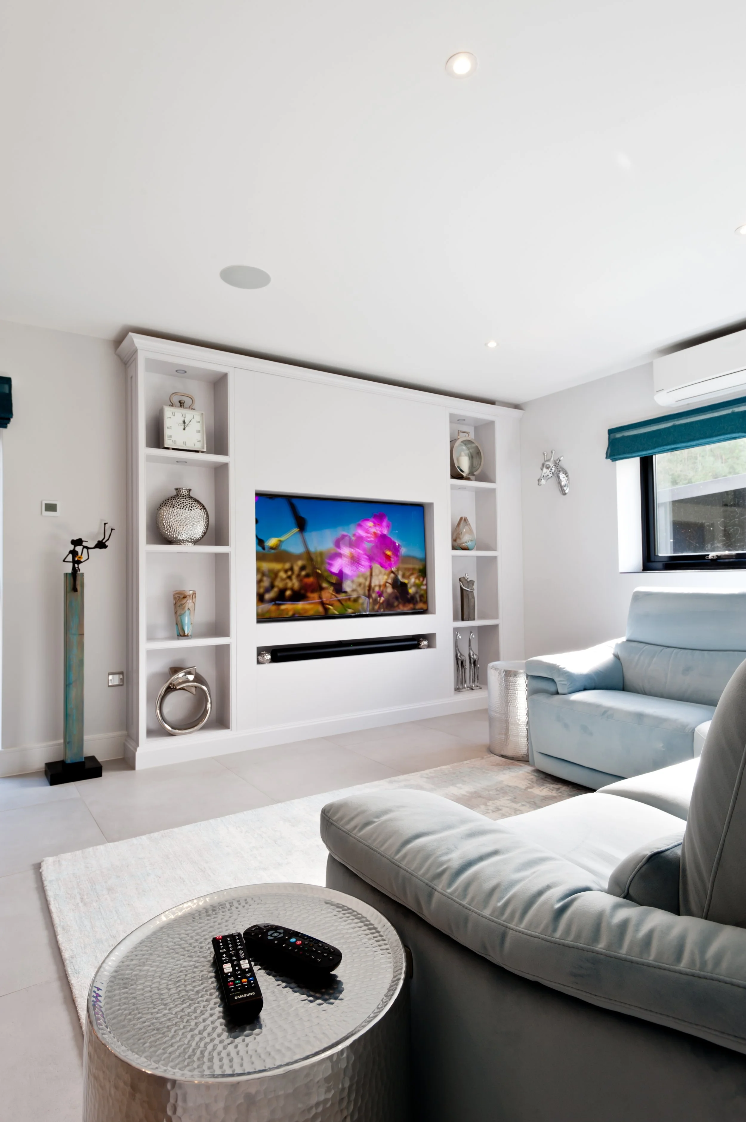 Now showing.
Bespoke media furniture designed around the television, with open display shelving becoming part of the room.