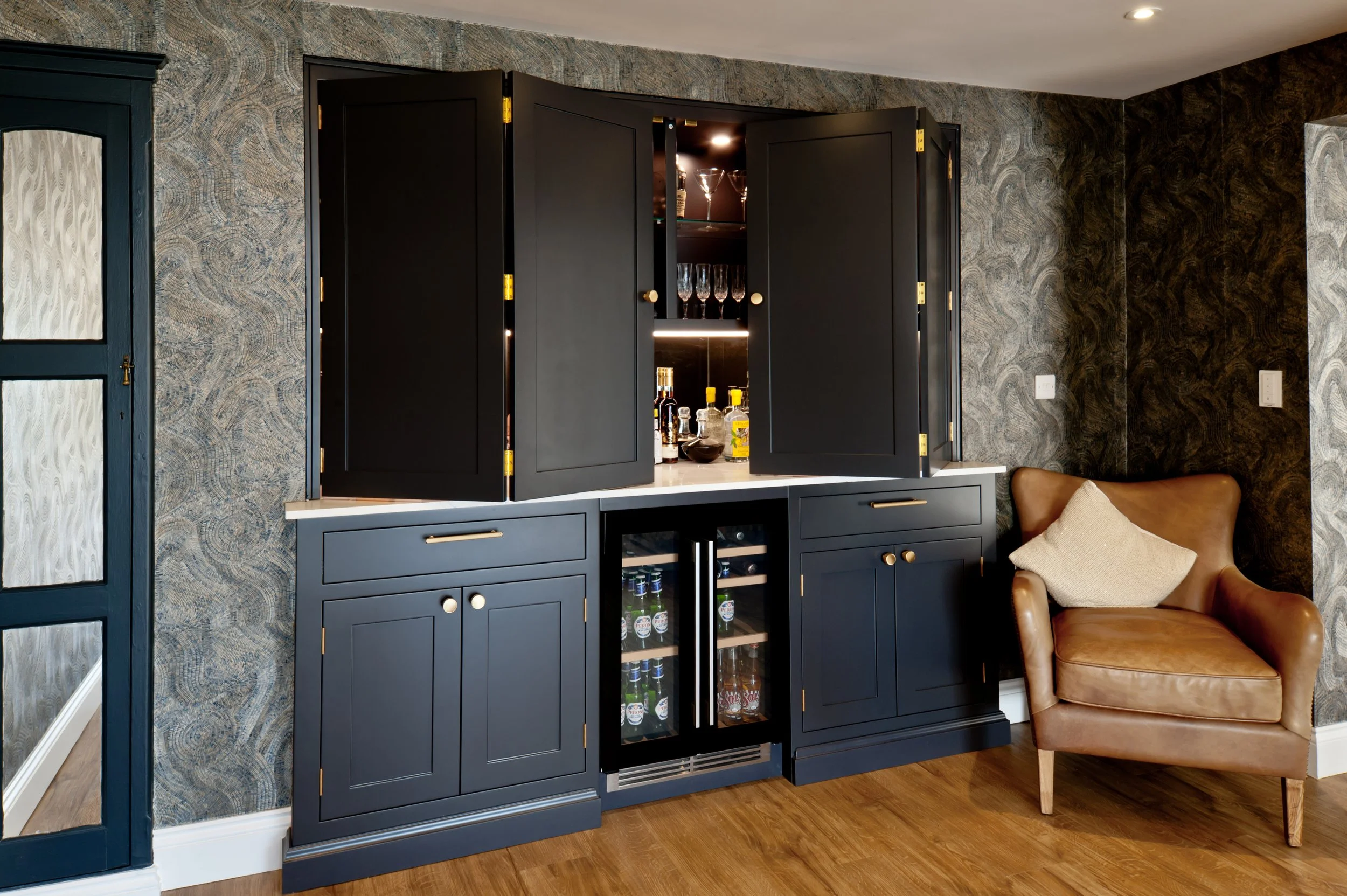 Drinks are on the house. Bespoke home bar cabinetry with integrated wine coolers and concealed drinks storage.