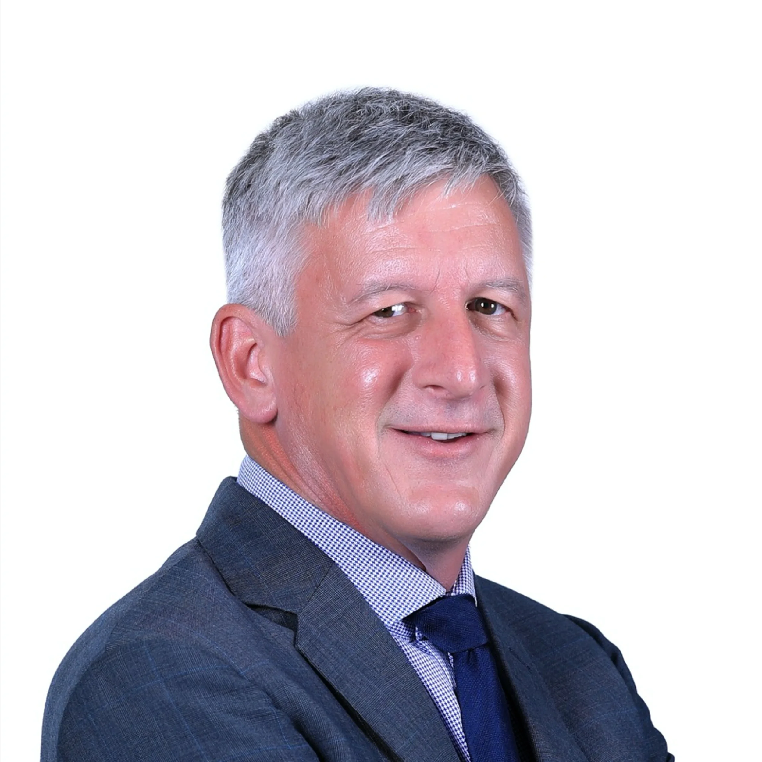 Professional headshot of Scott with gray hair, wearing a dark suit, collared shirt, and tie, against a white background.