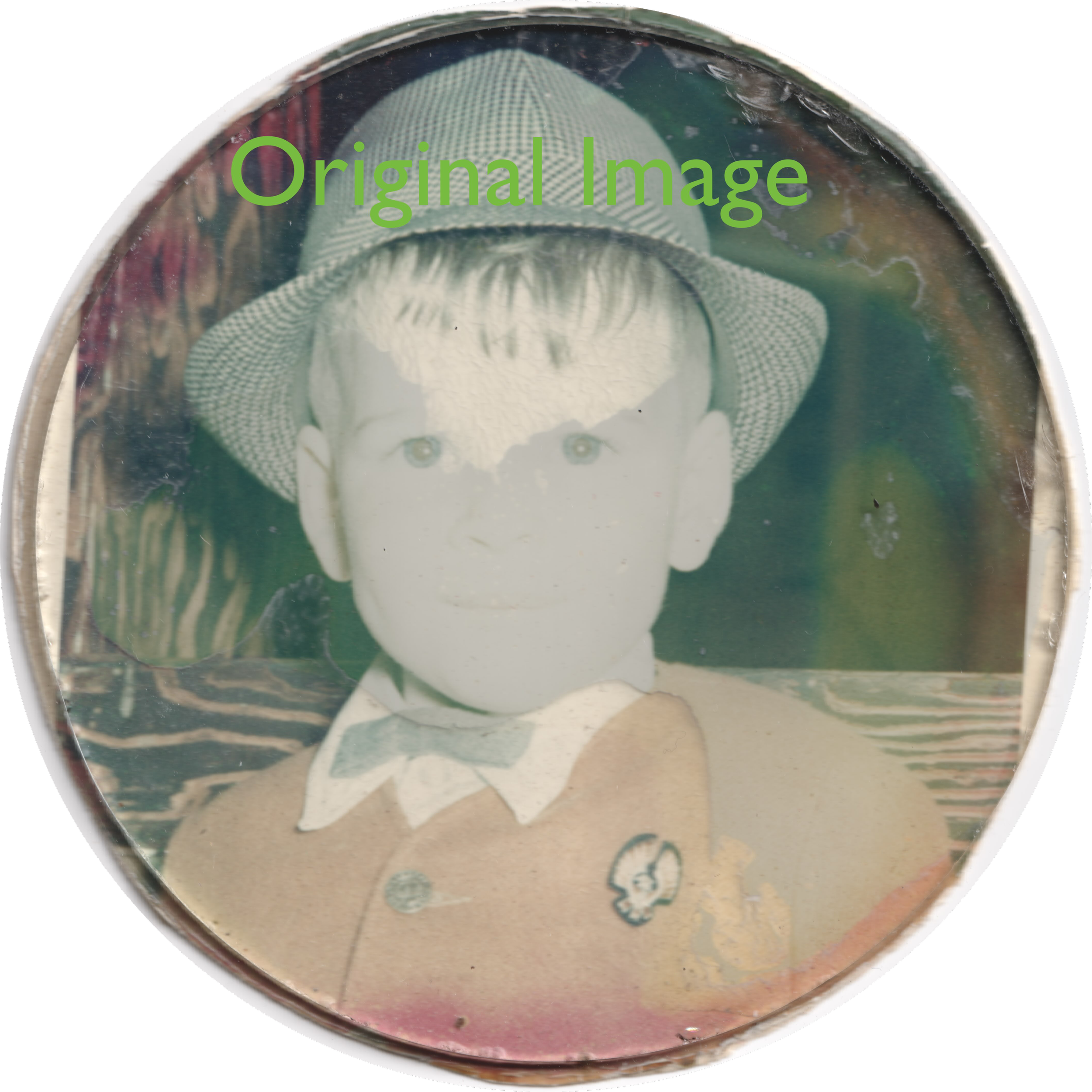 Top of a coin with a profile of a person's head wearing a hat, and a small detailed symbol or emblem beneath