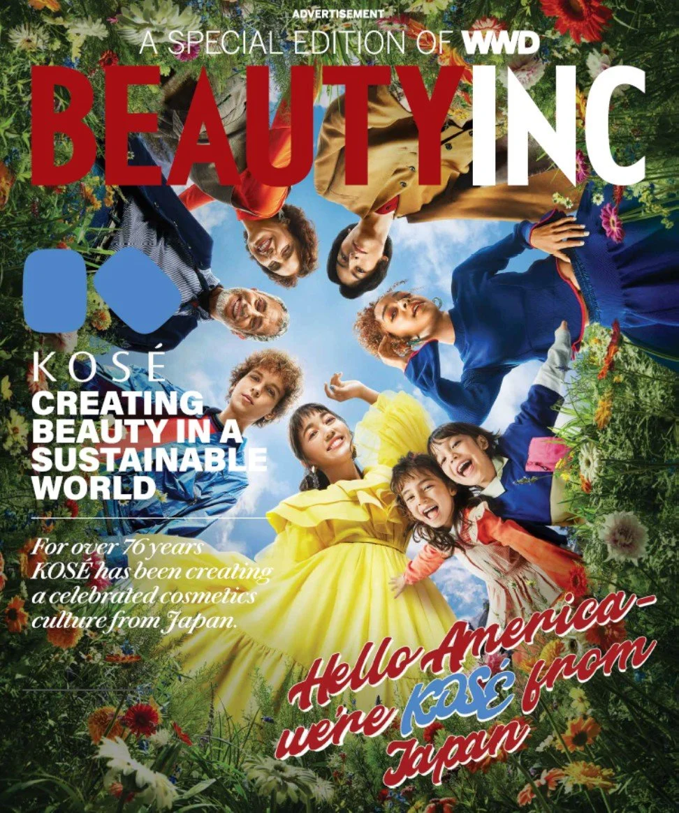 Magazine cover titled "Beautiful" with a group of diverse children and adults smiling and looking down at the camera, surrounded by flowers and greenery, with blue sky in the background. The cover features text about creating beauty and cosmics cultu