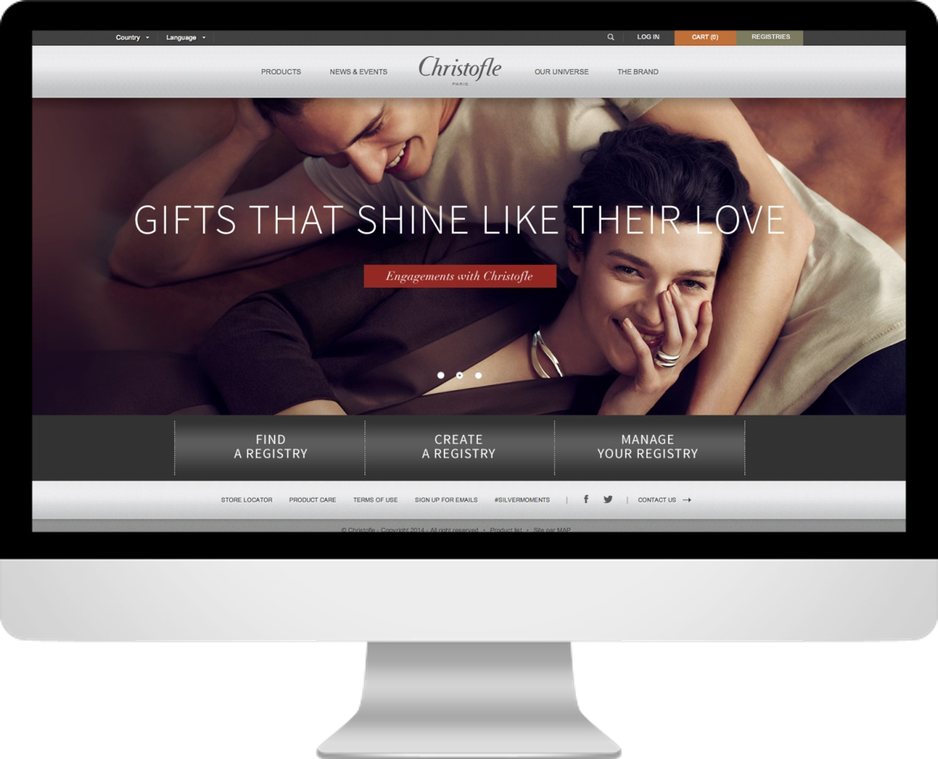 Screenshot of Christofle's website homepage featuring a smiling couple lying together, with the headline 'Gifts That Shine Like Their Love' and navigation options for finding, creating, and managing registries.
