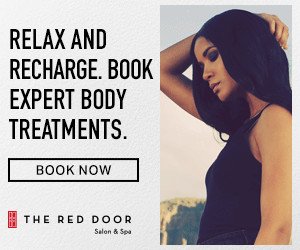 Advertisement for The Red Door Salon & Spa promoting relaxation, recharge, and expert body treatments with a woman with dark hair and a black sleeveless top.