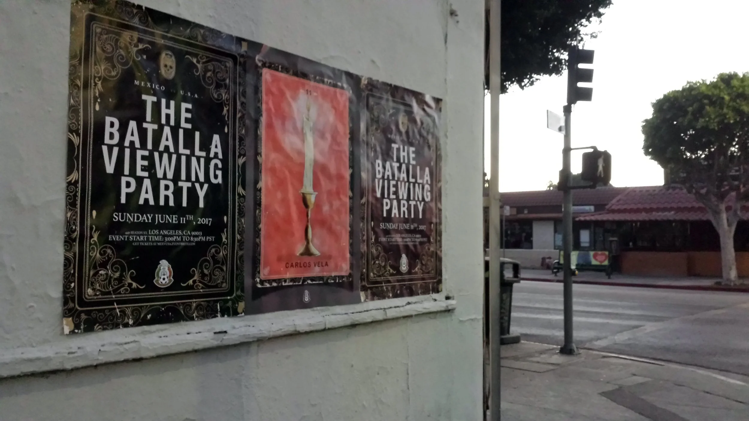 Posters on a wall advertising the Battala Viewing Party on Sunday, June 11th, 2017, featuring a black ornate design with skull and floral patterns, and a central candle illustration.