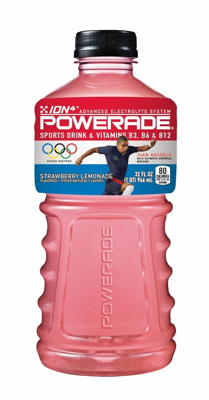 A pink plastic bottle of Powerade sports drink with a black cap, labeled as strawberry lemonade flavor, featuring an athlete and Olympic rings.