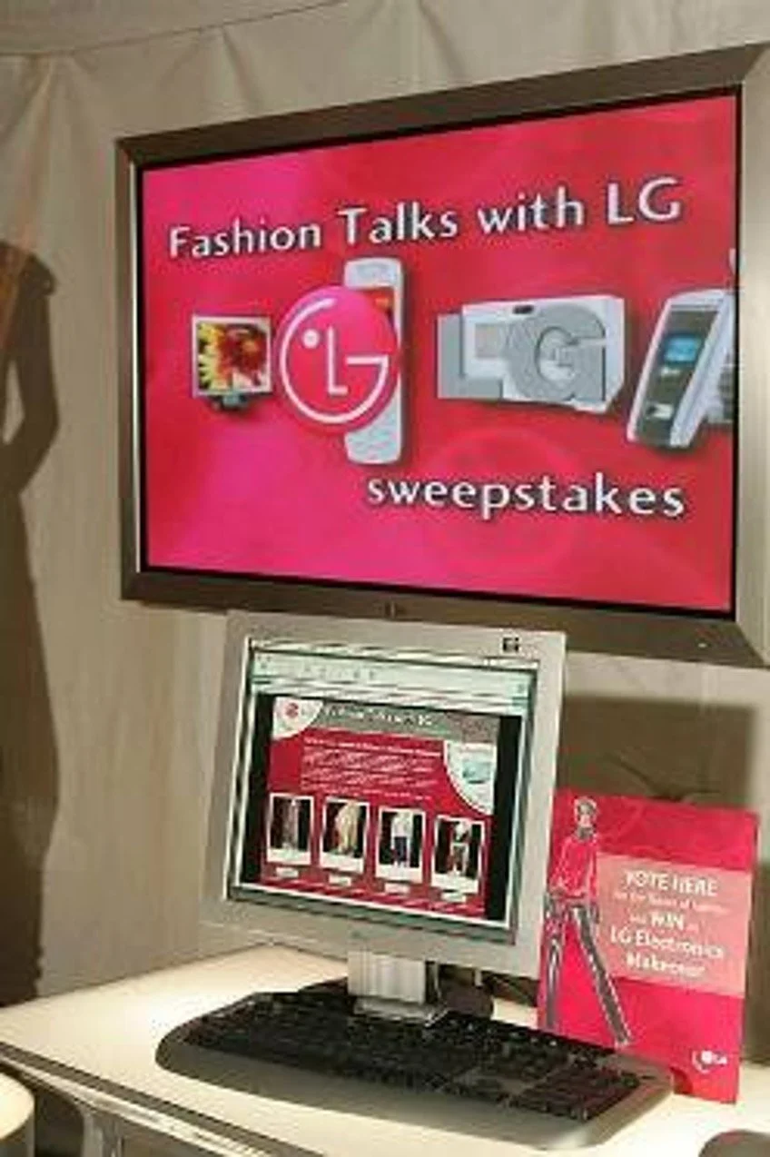 A digital display promoting an LG sweepstakes with the title "Fashion Talks with LG" and images of LG products like a TV, a microwave, and a mobile phone.