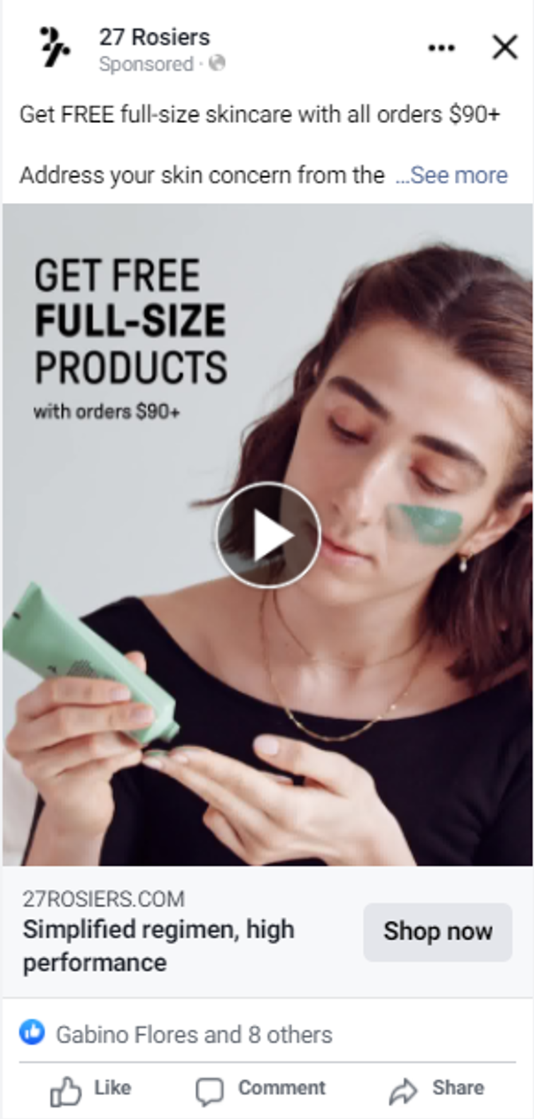 A woman applying skincare product to her face and holding a tube of skincare cream in her other hand, promoting free full-size skincare products with orders over $90.