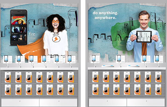 Display panels showcase various smartphones and tablets with promotional images and slogans. The left side features a woman with curly hair and glasses, smiling with a superhero cape, advertising a phone app. The right side shows a man holding a tablet, with a cityscape background and the words 'do anything. anywhere.'