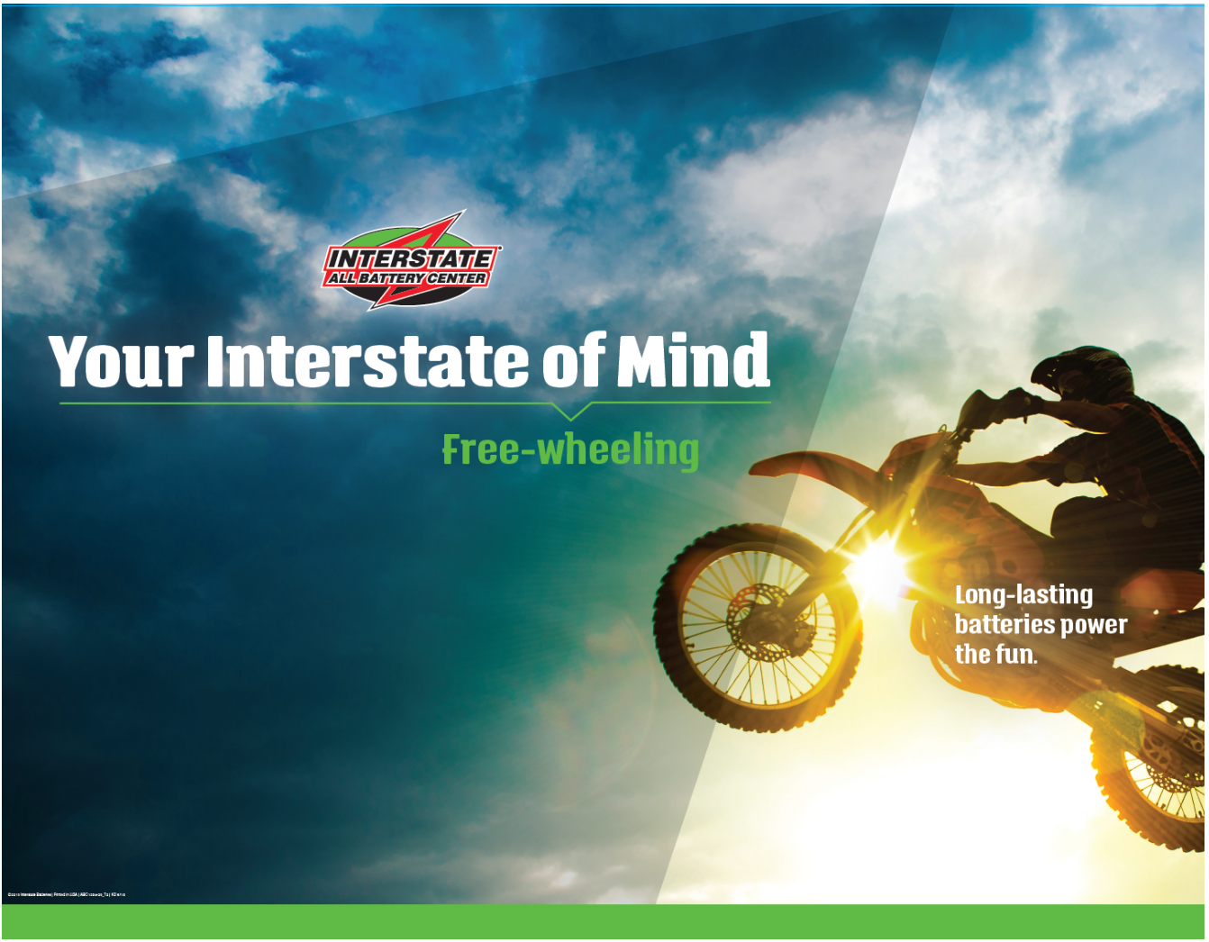 A motorcyclist performing a jump at sunset with the sky and clouds in the background, promoting Interstate All Battery Center with text indicating 'Your Interstate of Mind' and keywords about long-lasting batteries.