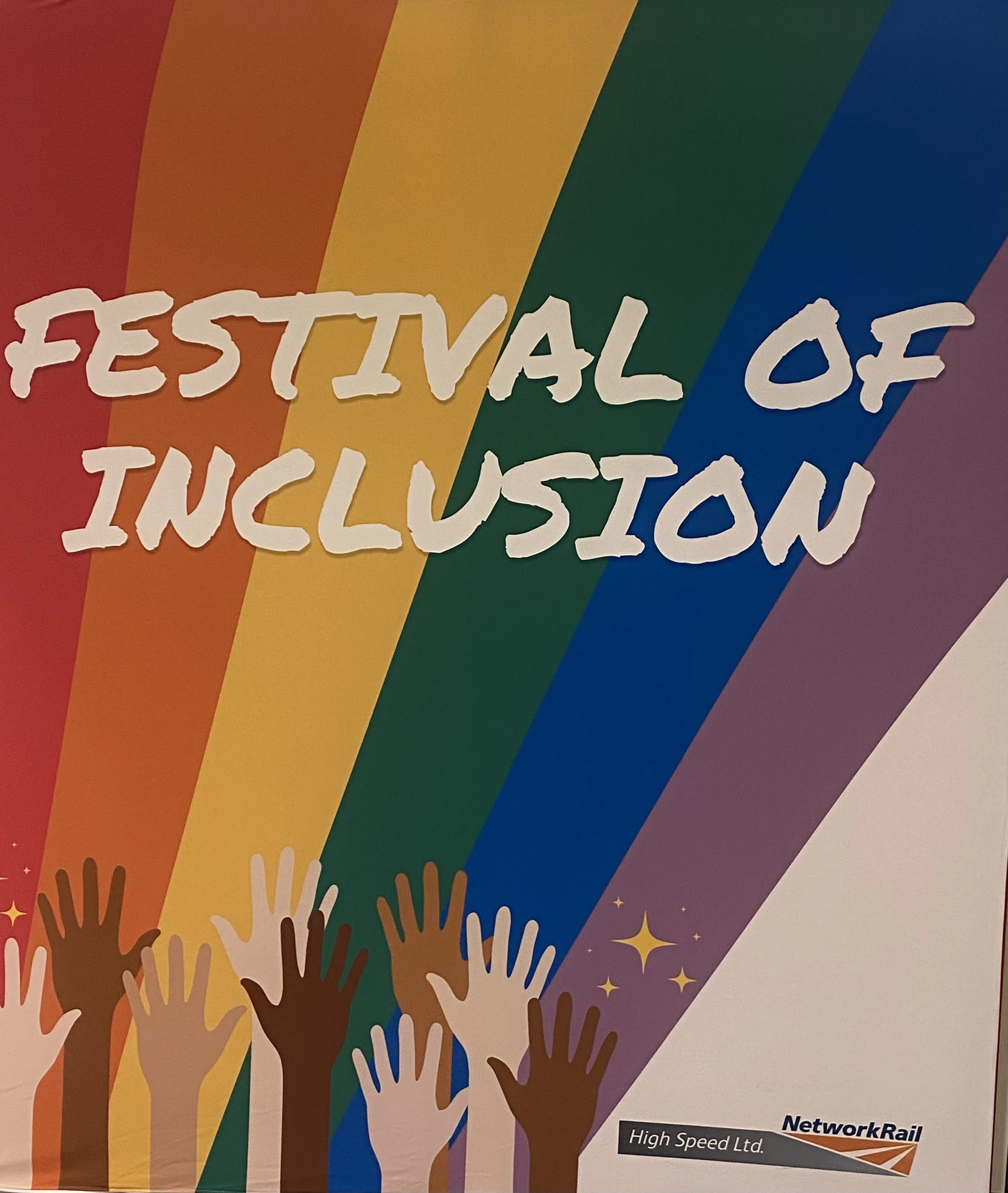 A poster titled 'Festival of Inclusion' with colorful rainbow stripes and raised diverse hands at the bottom, featuring small stars and the Network Rail logo.
