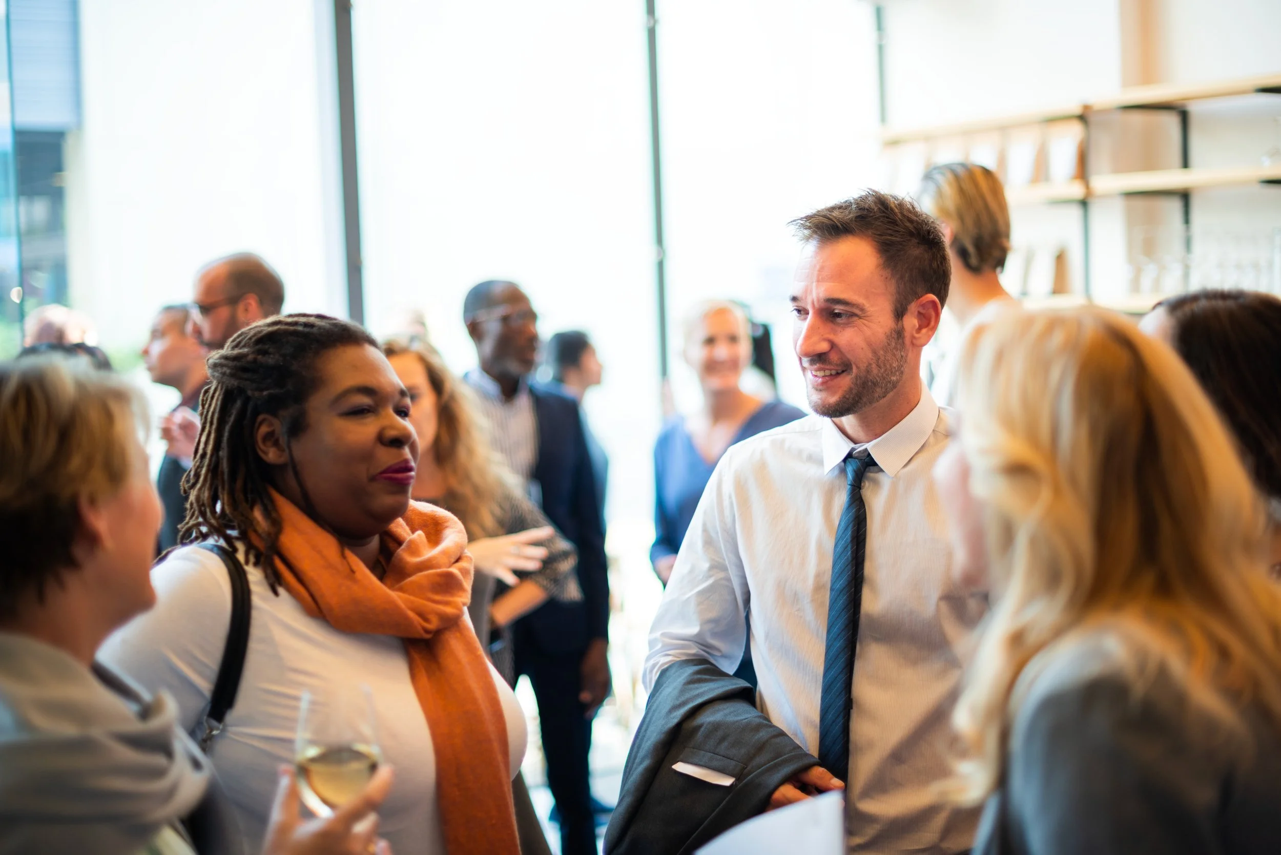 People socializing at a professional event or networking gathering