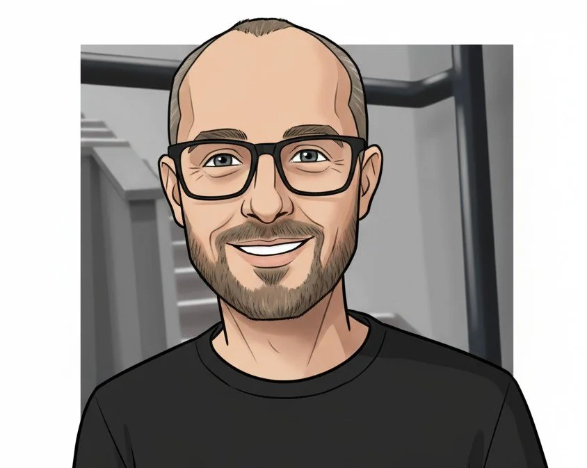 Cartoon of a smiling man with glasses, a beard, and short hair, wearing a black t-shirt.