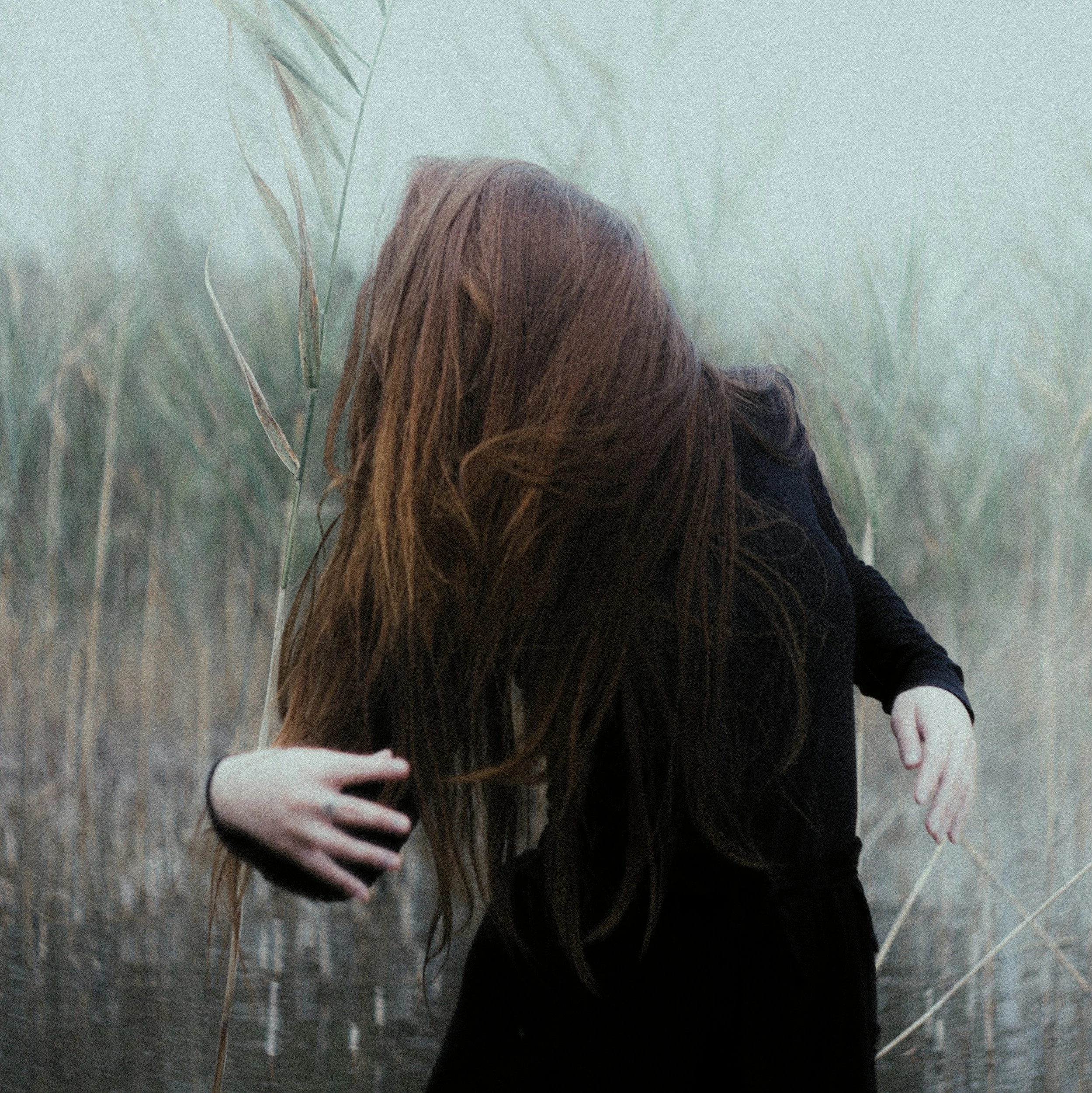 Semi-abstract image of a woman with her hair covering her face, representing fear of closeness, relationship struggles, and trauma from the past