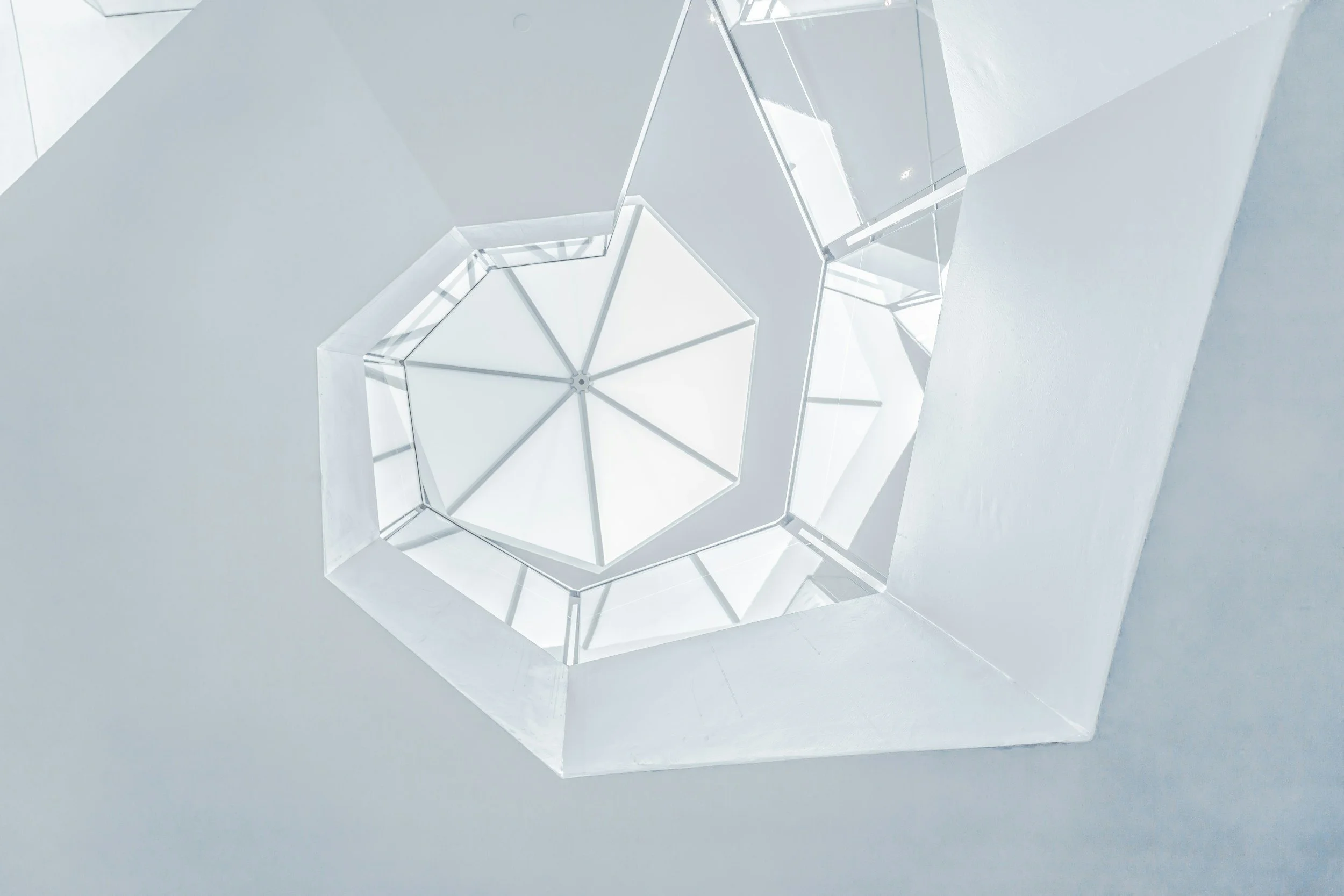 Geometric glass skylight with layered panels, symbolising structure and organisation of internal experience in psychotherapy