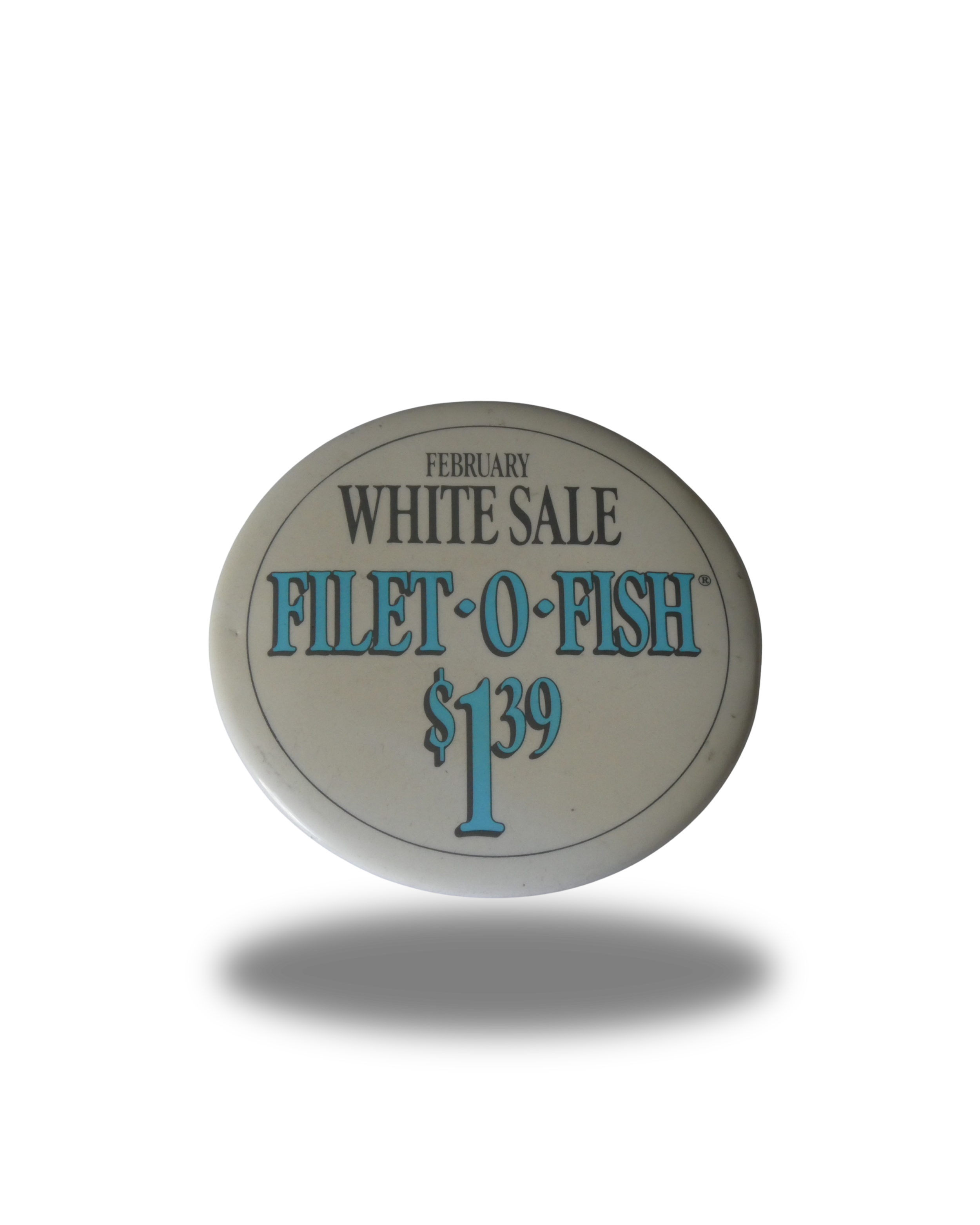 A round sign advertising a February sale on fish fillets for $1.39 at a store called FILET O FISH.