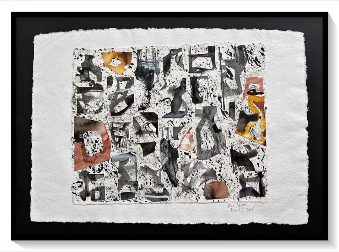 Abstract collage artwork with torn paper, black and white splatters, and hints of red, yellow, and orange, mounted on a textured white mat and framed in black.