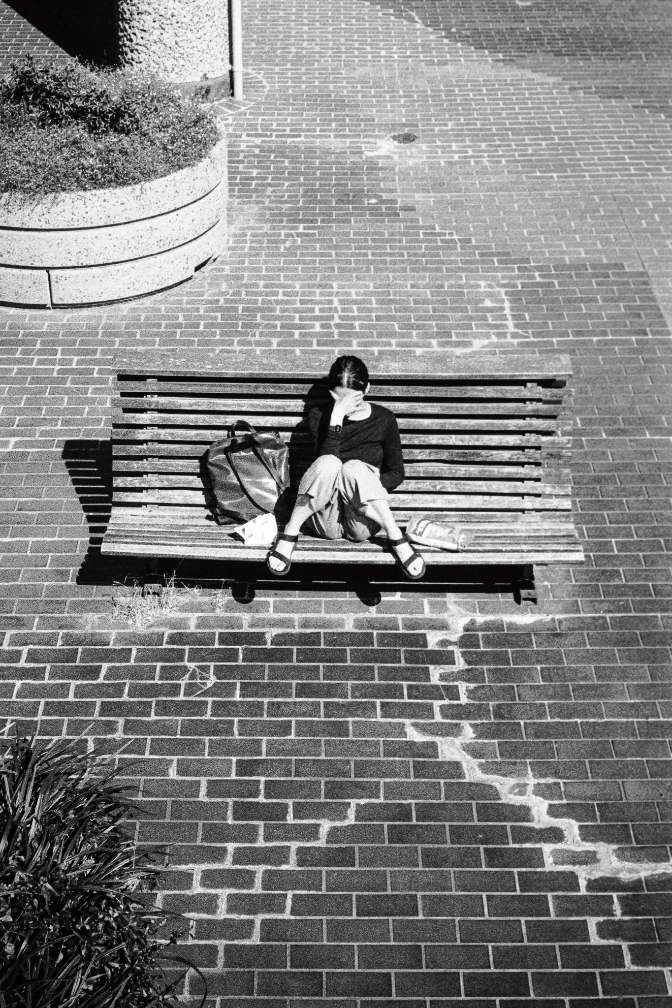 Looking at a phone in the sun - Barbican, 2022