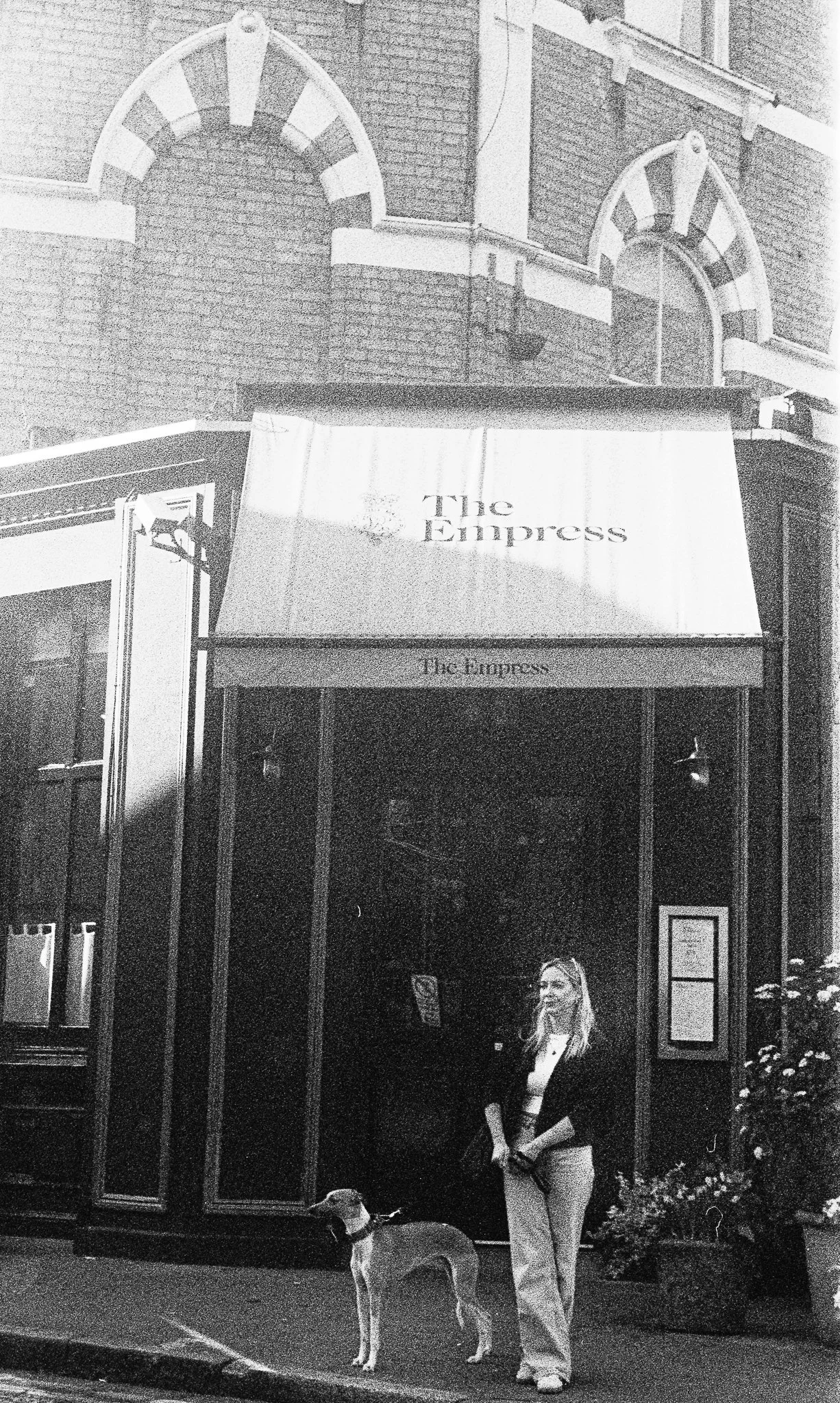 Lady in front of a pub. London. 2025
