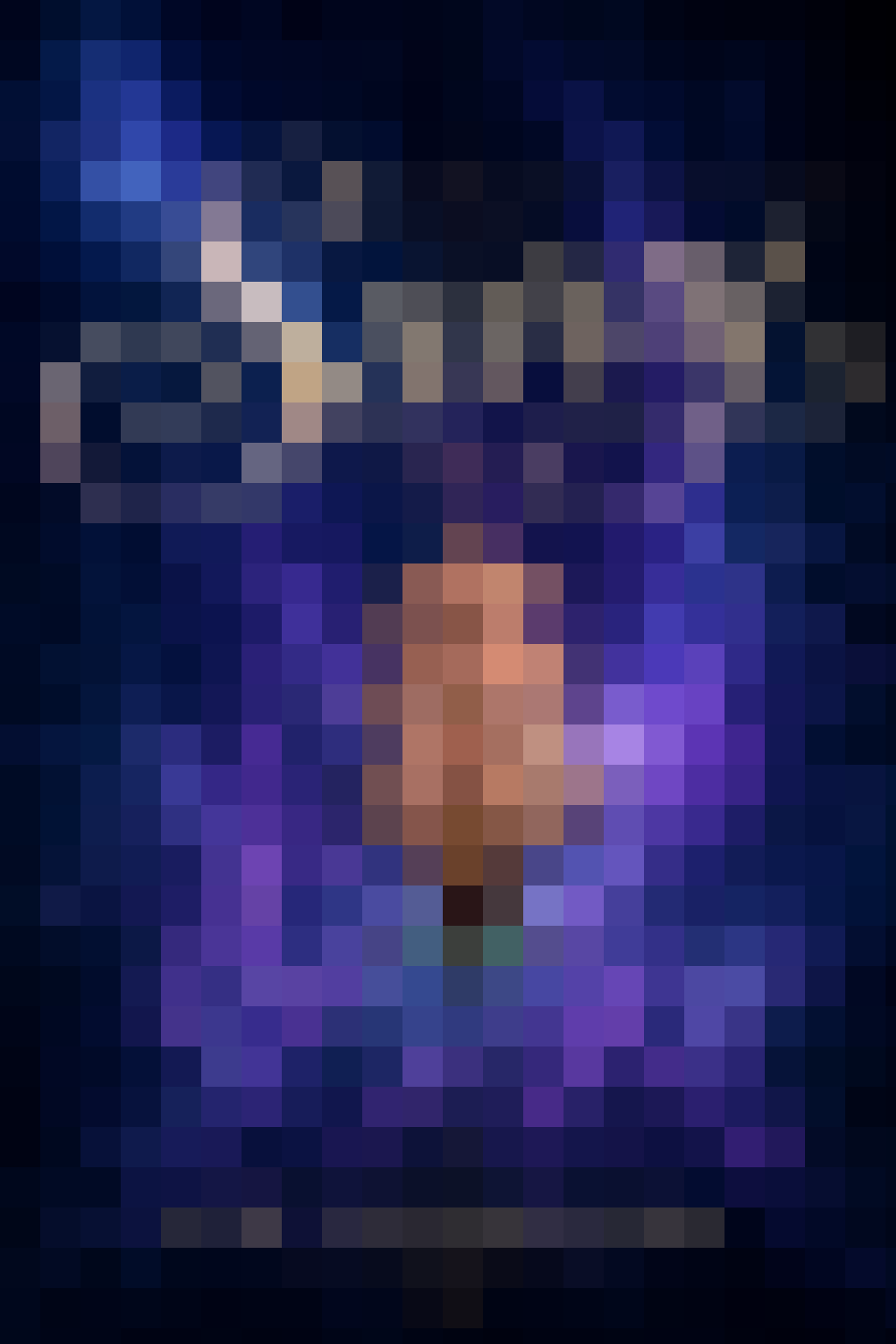 A blurred book cover with pink, orange, blue-ish purple colours.