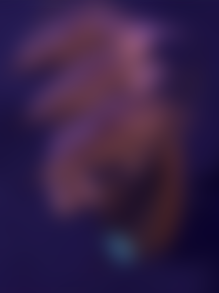 A blurred book cover with pink, orange, blue-ish purple colours.
