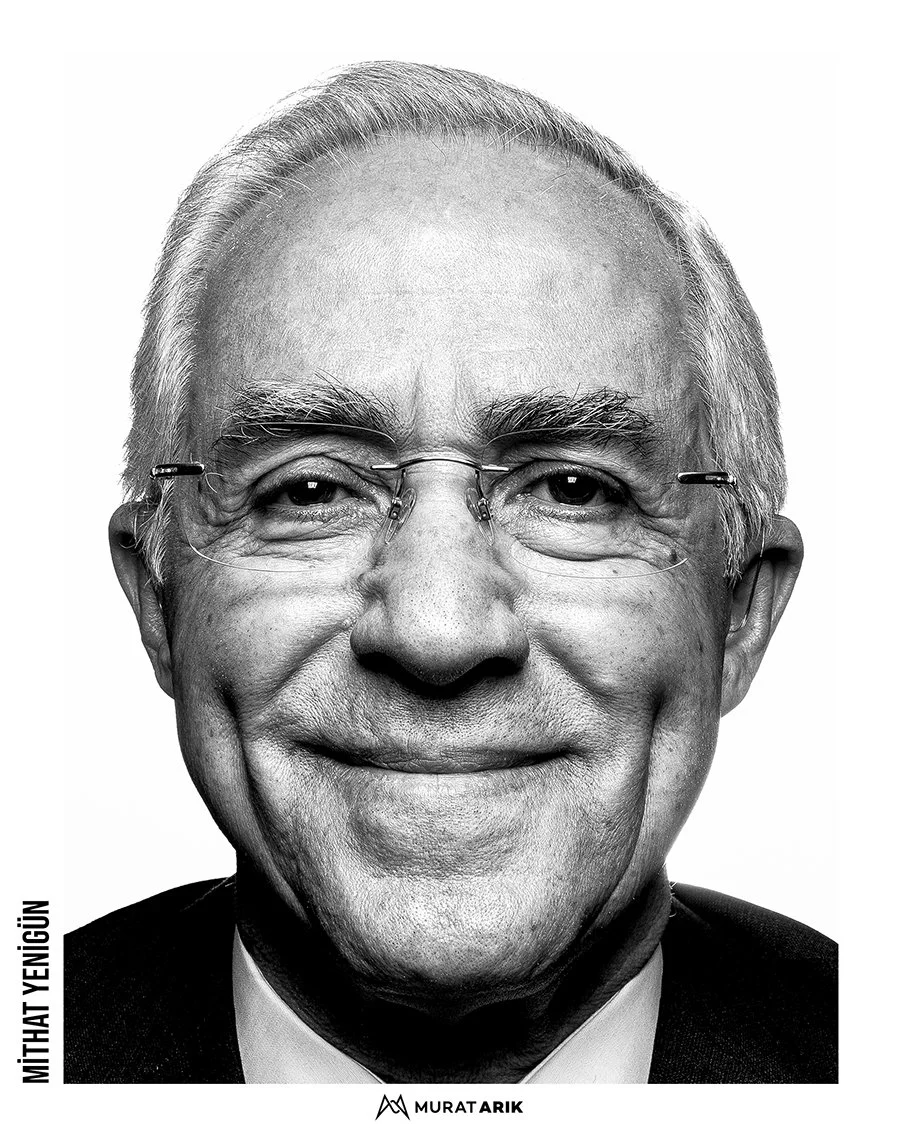 Black and white portrait of an elderly man with glasses, smiling, with short, light-colored hair.