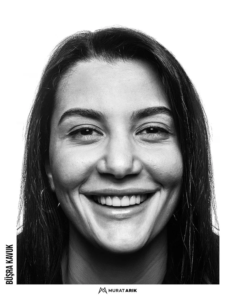 Close-up black and white portrait of a smiling woman with long dark hair