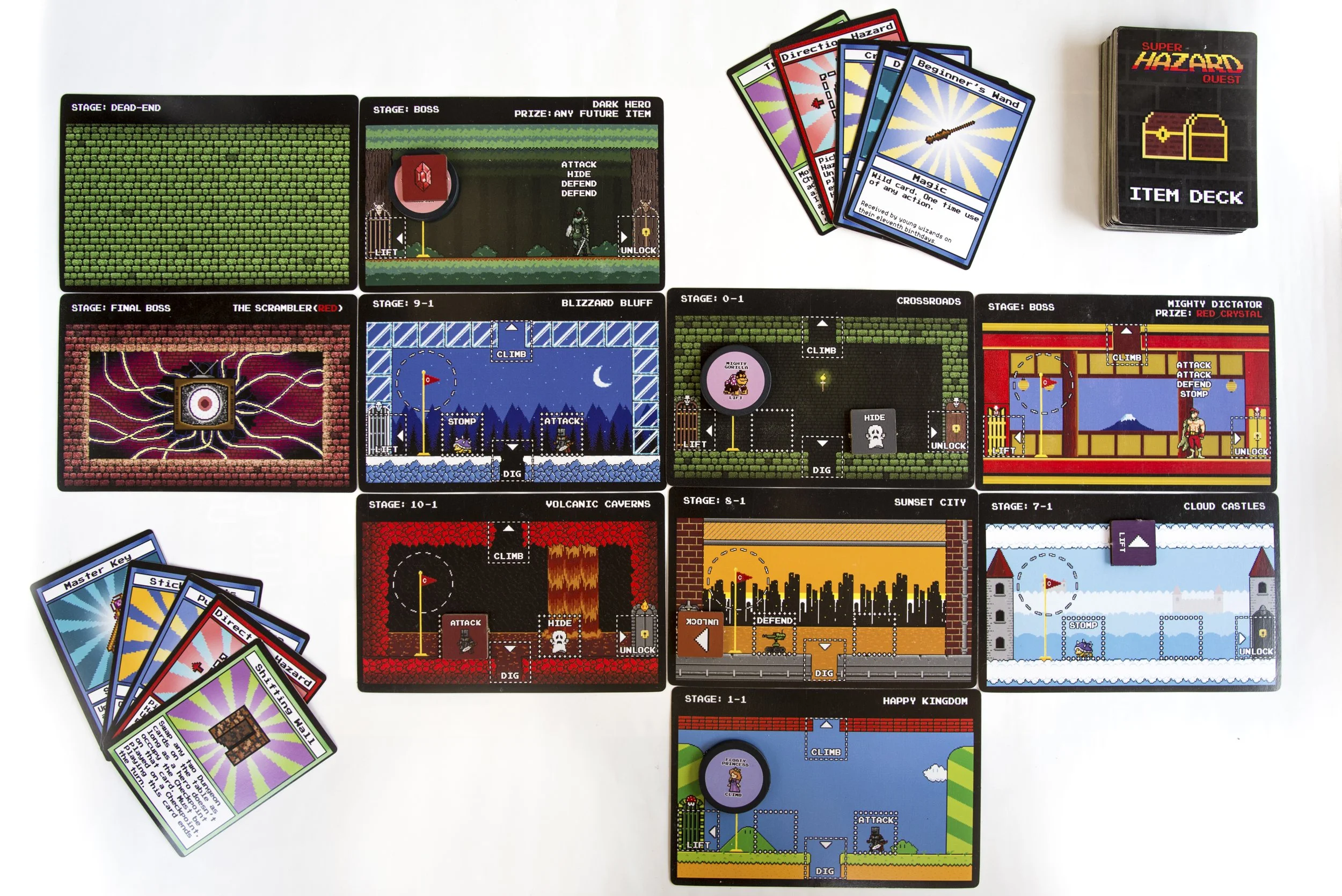 A collection of cards, game tiles, and a small deck box for the card game Super Hazard Quest. The game tiles depict various levels and stages with different themes and objectives, with some showing environments like a snowy castle or volcanic caves. 