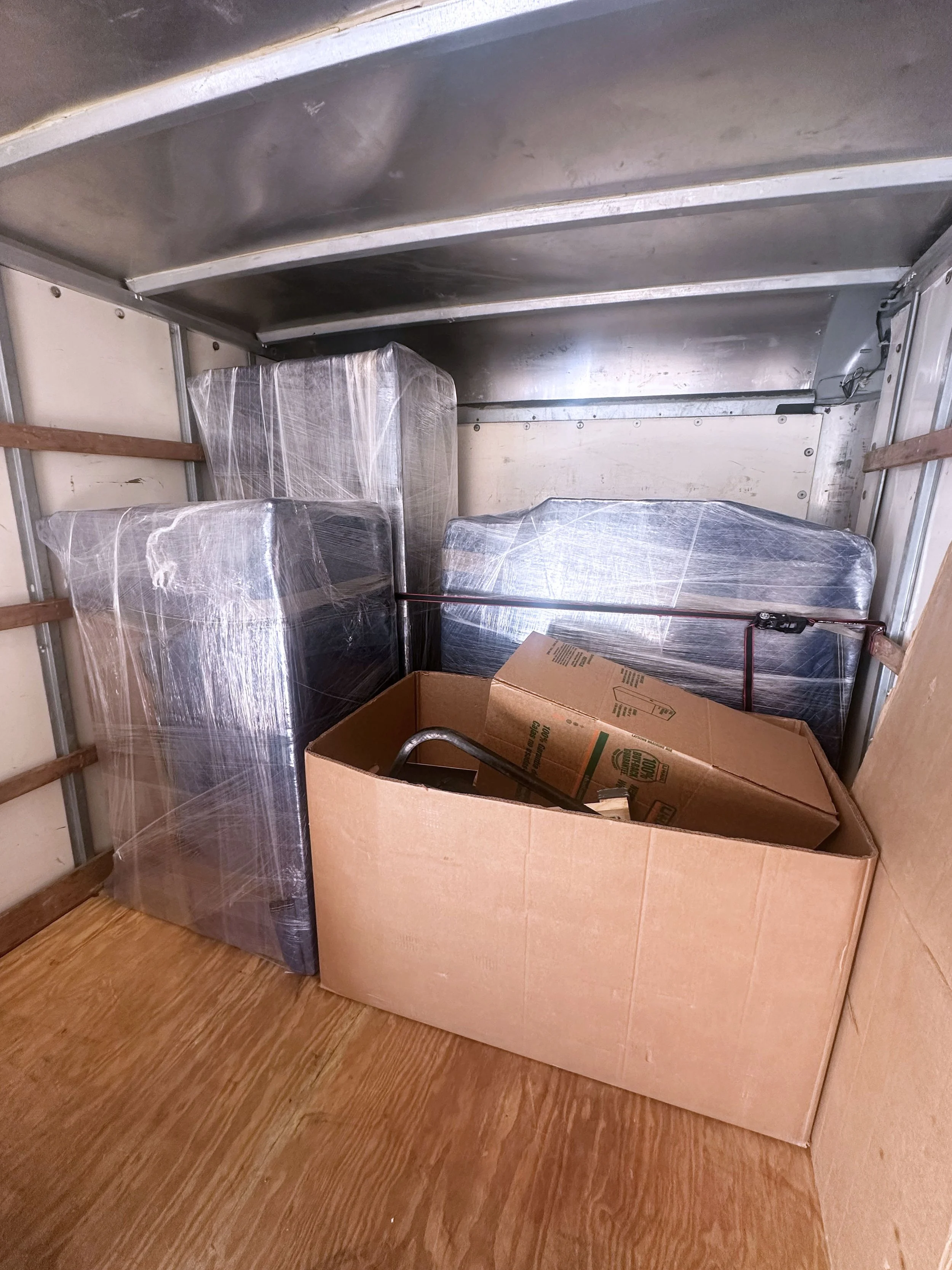 Small move packed and organized in a truck by Easy Peasy Moving, LLC in Central Florida, featuring securely loaded furniture, boxes, and household items.