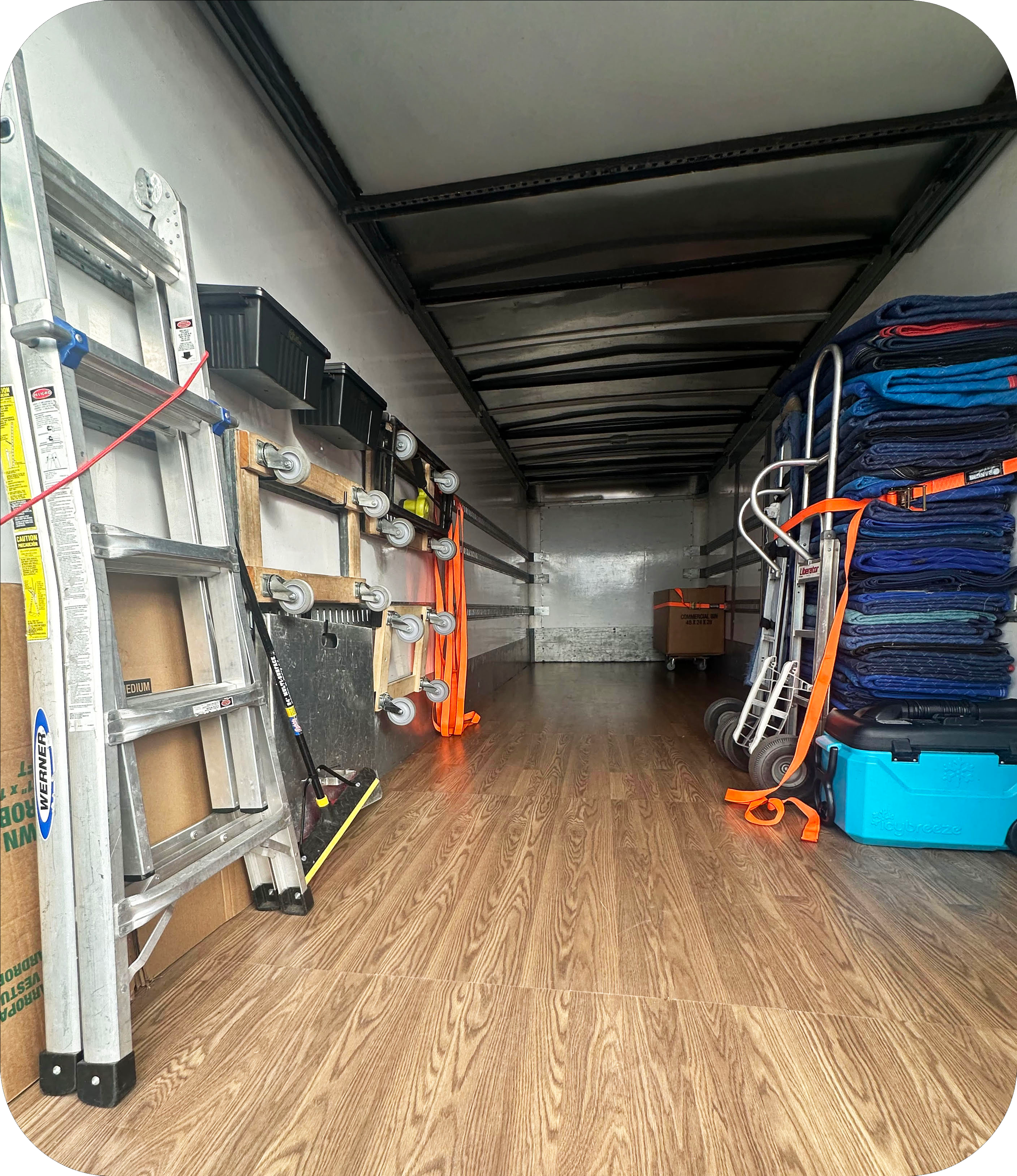 Inside of a moving truck with neatly organized moving blankets, dollies, straps, and equipment used by Easy Peasy Moving, LLC in Central Florida