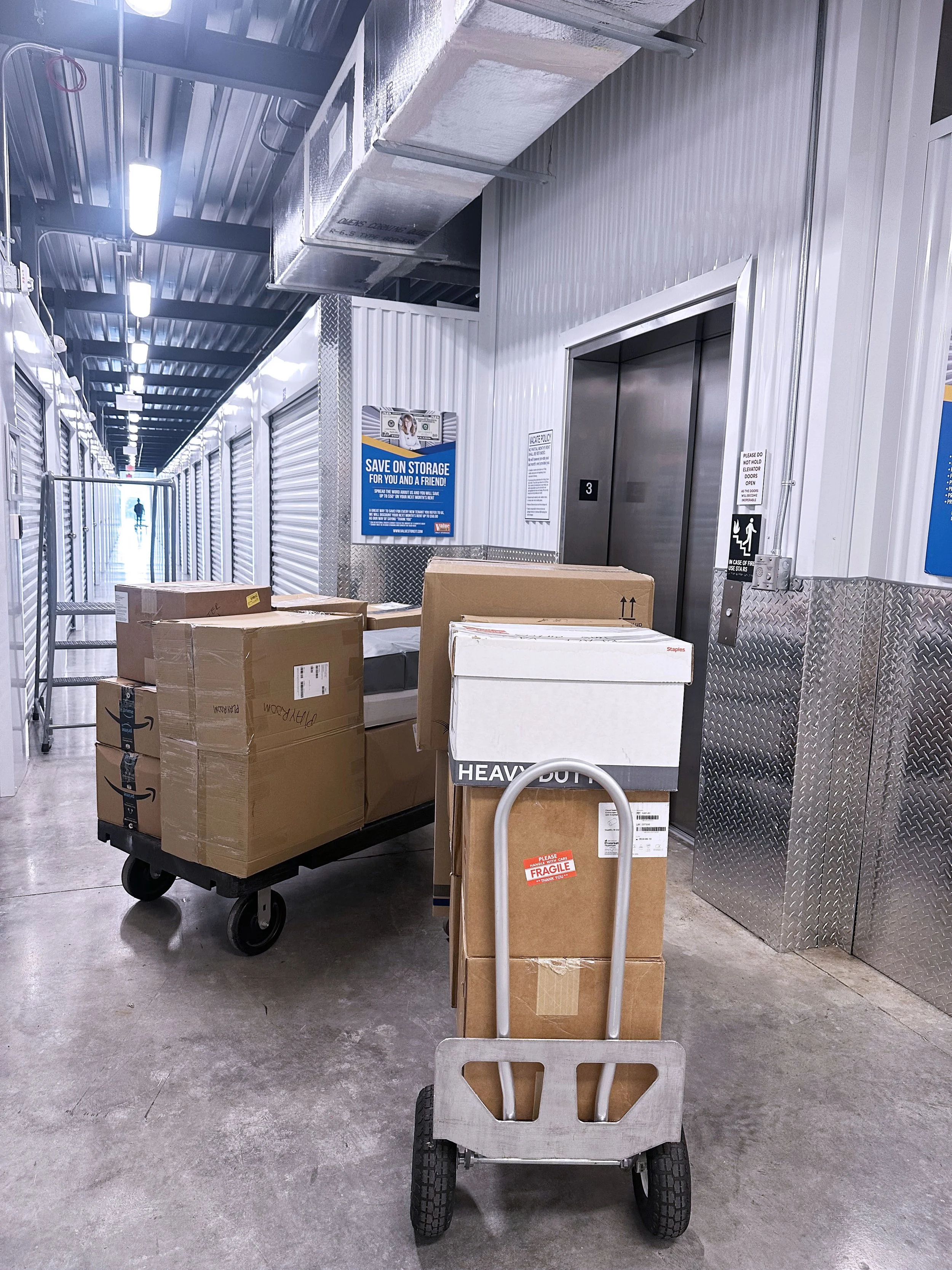 Easy Peasy Moving, LLC crew carefully moving boxes and items within a storage unit during a move in Florida.