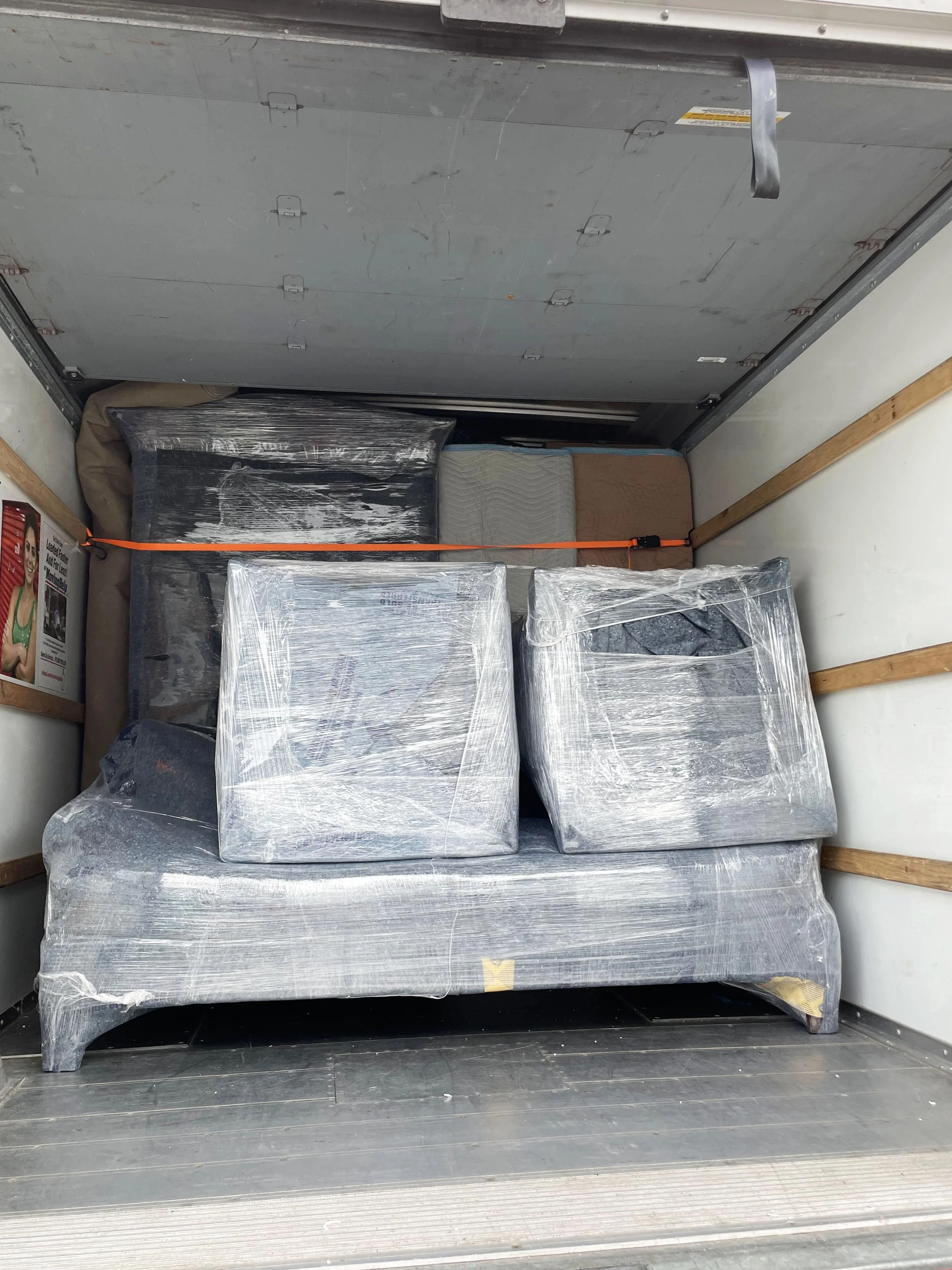 Packed items being loaded onto an Easy Peasy Moving, LLC truck during a move in Florida.