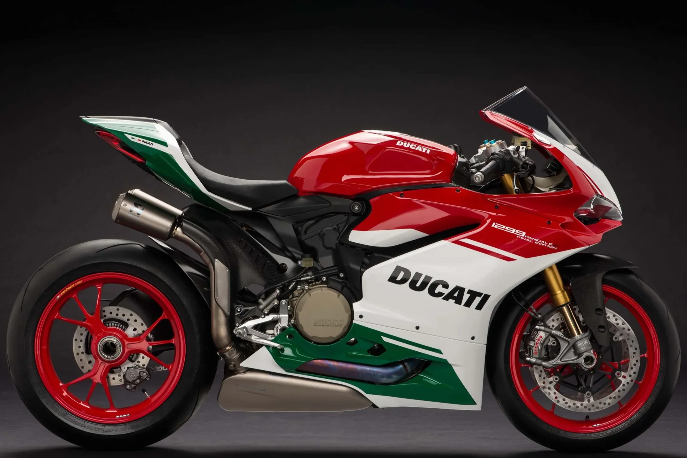 Red, white, and green Ducati Panigale V4 motorcycle against a dark background.