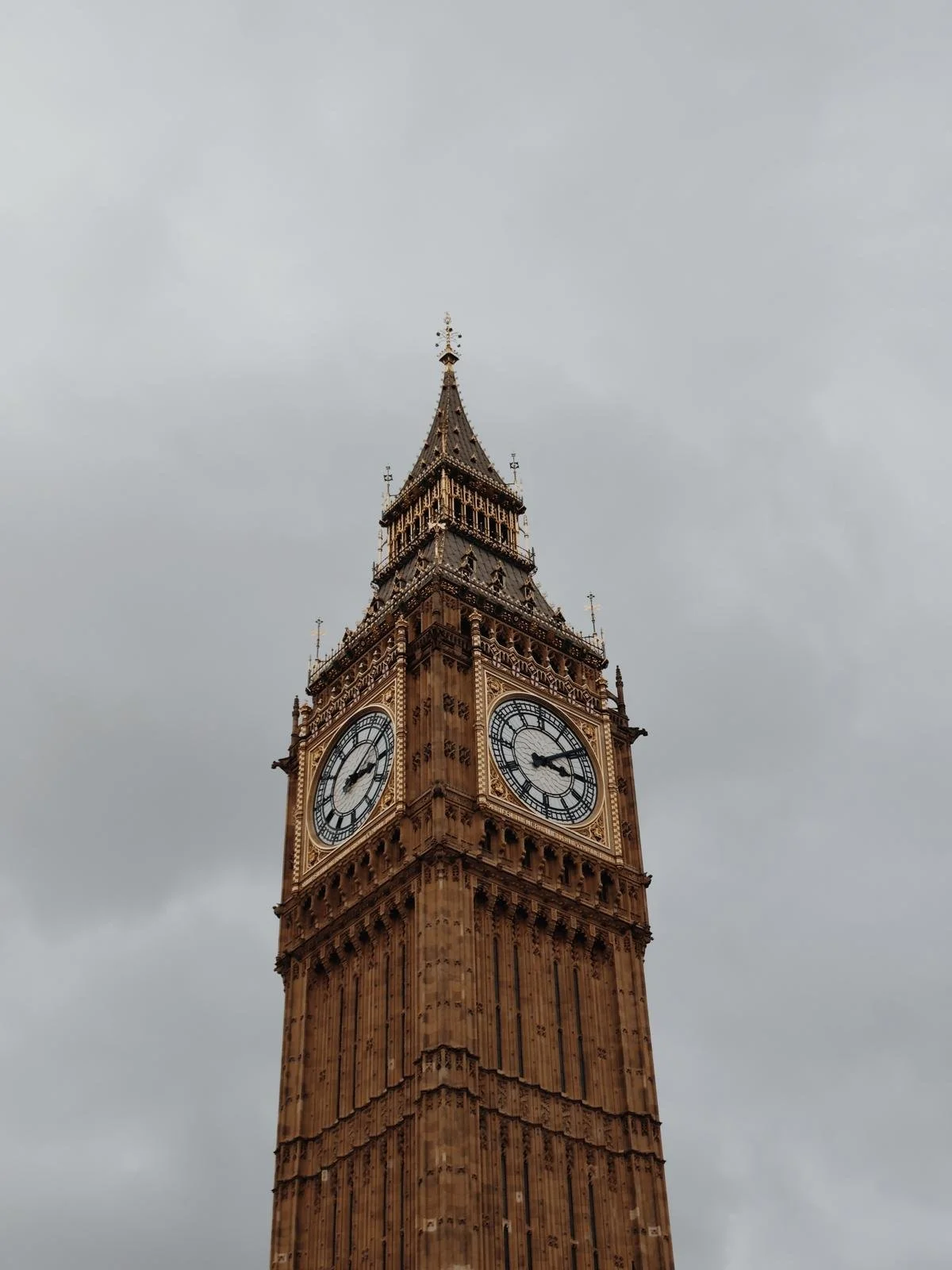 View of the clock tower, known as Big Ben, under an overcast sky.