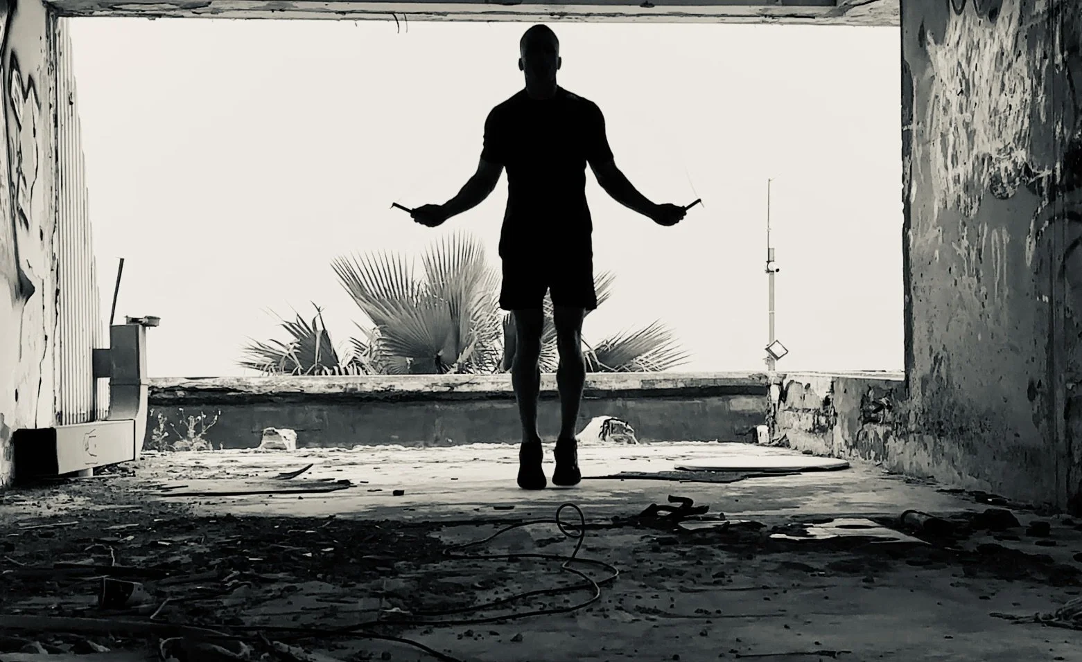 Black and white photo of a man skipping rope