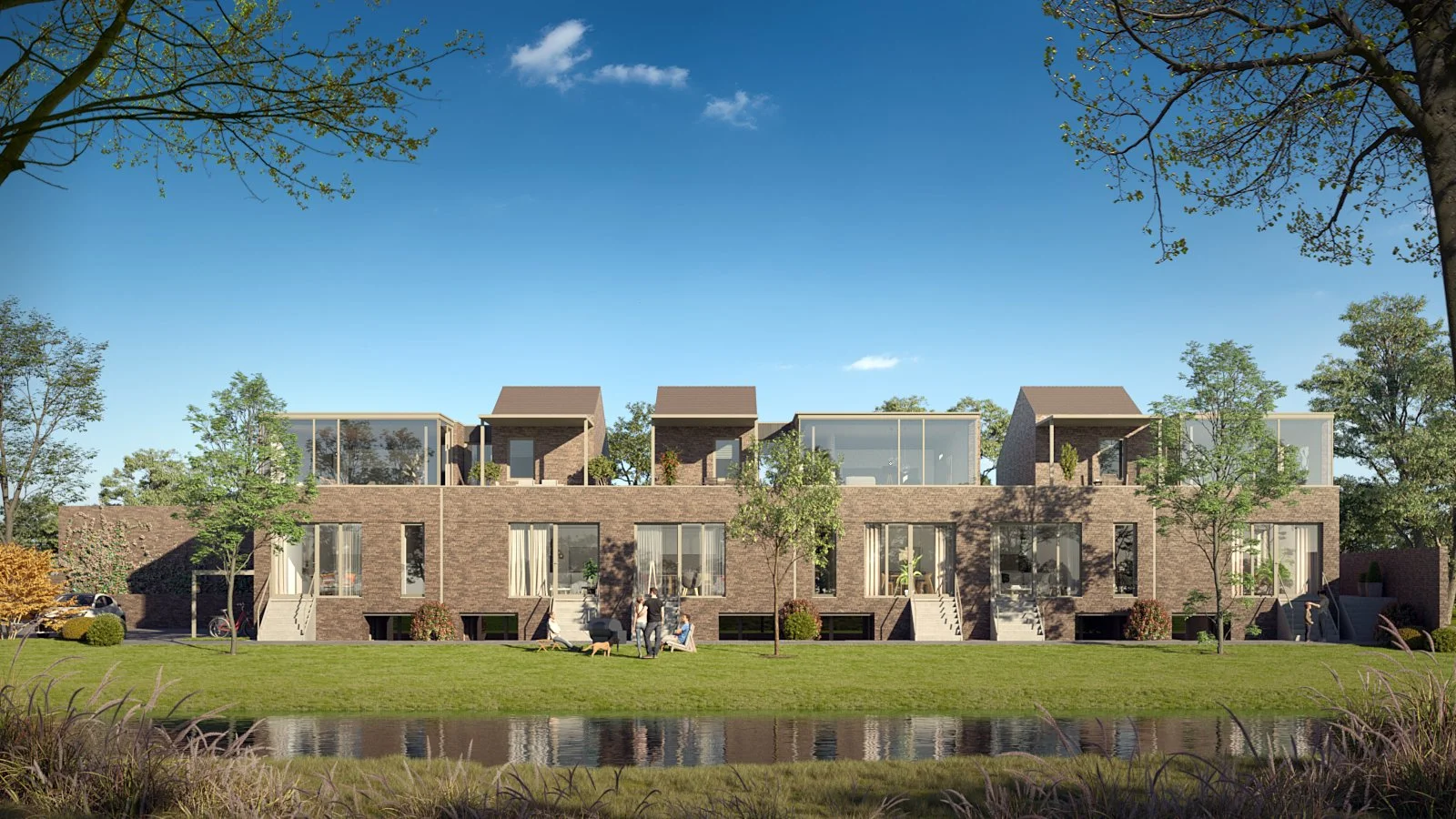 Modern multi-story residential building with brick exterior, large windows, and small rooftop patio spaces, set in a landscaped area with trees, grass, and a pond in the foreground.