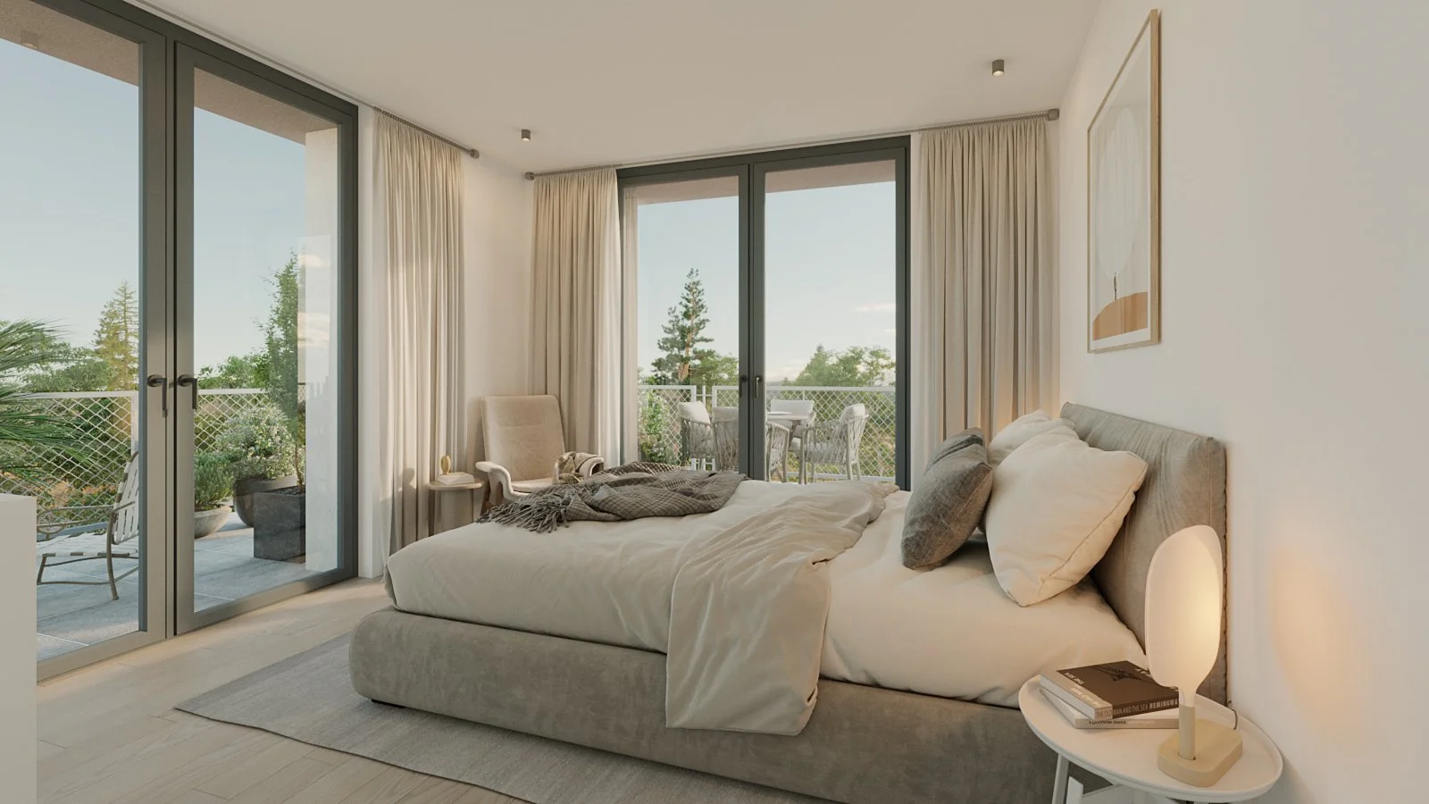 Modern bedroom with large glass sliding doors leading to a balcony with outdoor chairs and greenery, a cozy bed with pillows and a throw blanket, and a round white nightstand with a minimalist lamp and books.