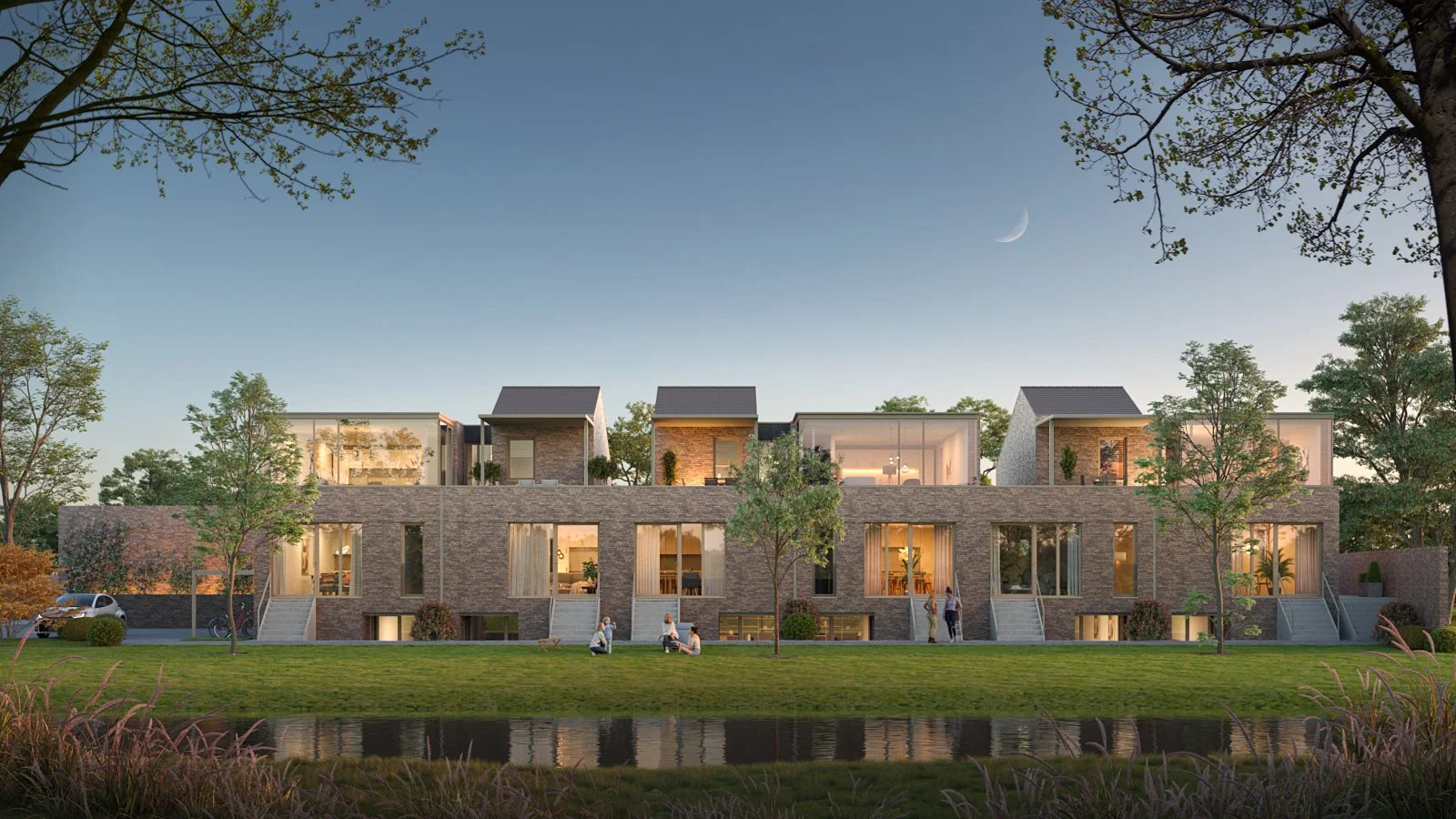 A modern multi-story residential building with large glass windows, surrounded by trees and a grassy lawn, with a pond in the foreground.
