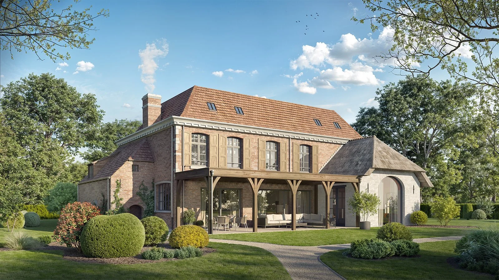 A large two-story brick house with a sloped red-tile roof, surrounded by greenery and a manicured lawn, with outdoor seating on a covered patio.