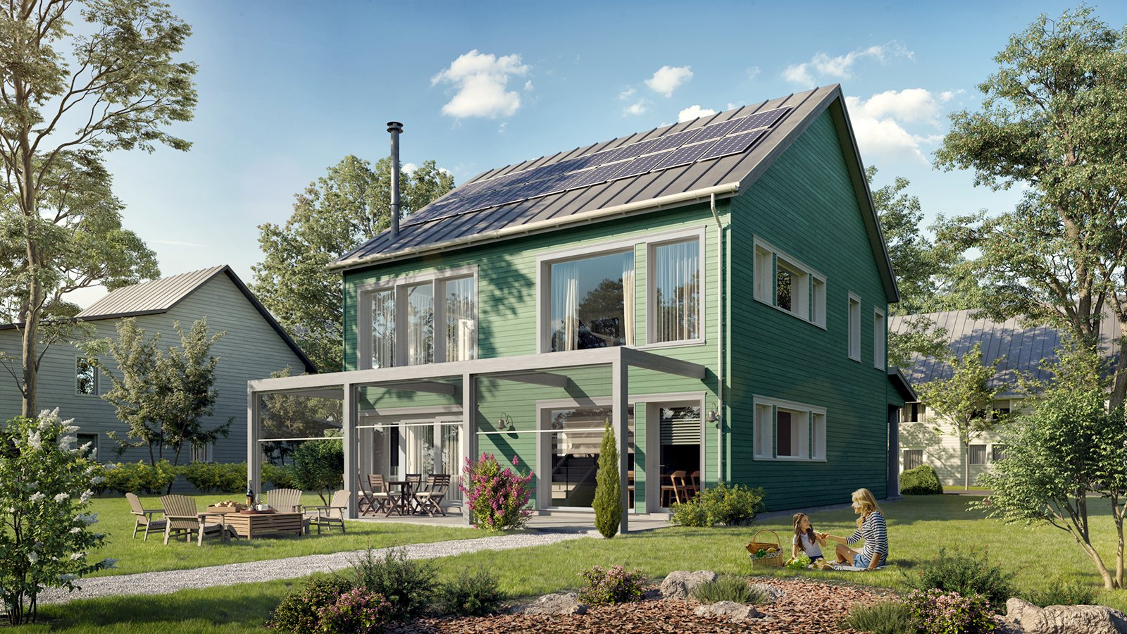 Green two-story house with solar panels on the roof, large glass sliding doors, a covered patio, and a backyard with a woman and child sitting on the grass, surrounded by trees and landscaping.