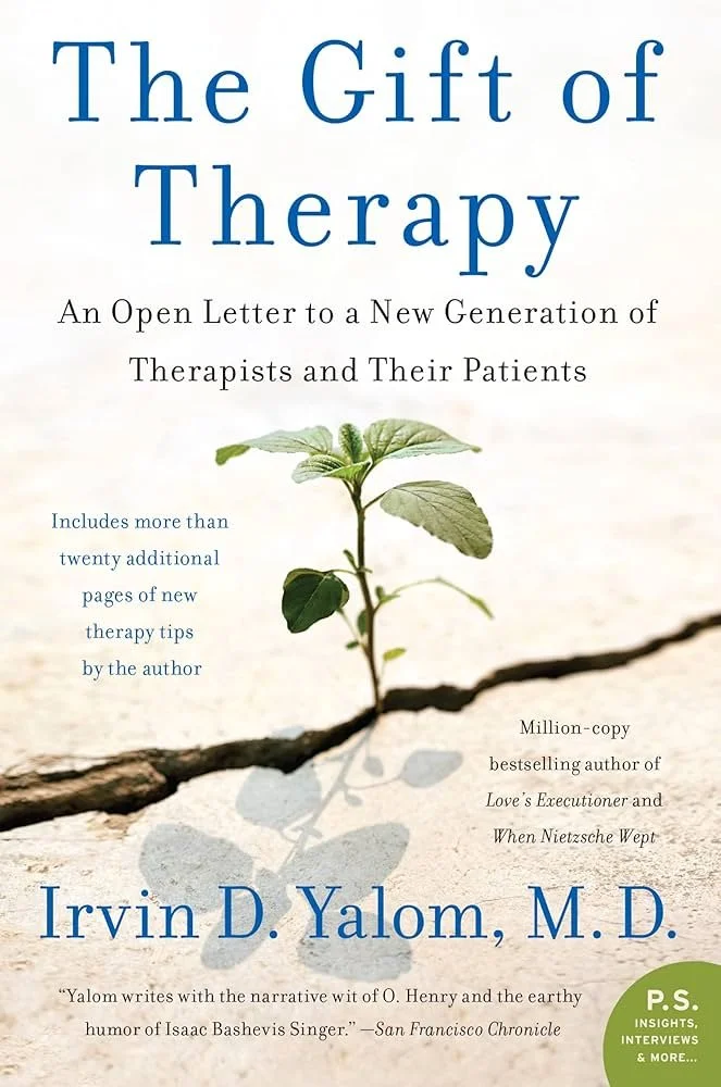 Book cover titled 'The Gift of Therapy' by Irvin D. Yalom, M.D., featuring a small green plant sprouting from a crack in dry, cracked earth with its shadow.