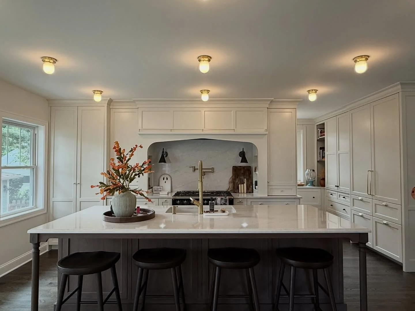 This beautiful and transformative kitchen remodel breathes new life into a 100-year-old bungalow, honoring its traditional forms while adapting it for modern living. By thoughtfully opening the rear of the home, the project created a light-filled and