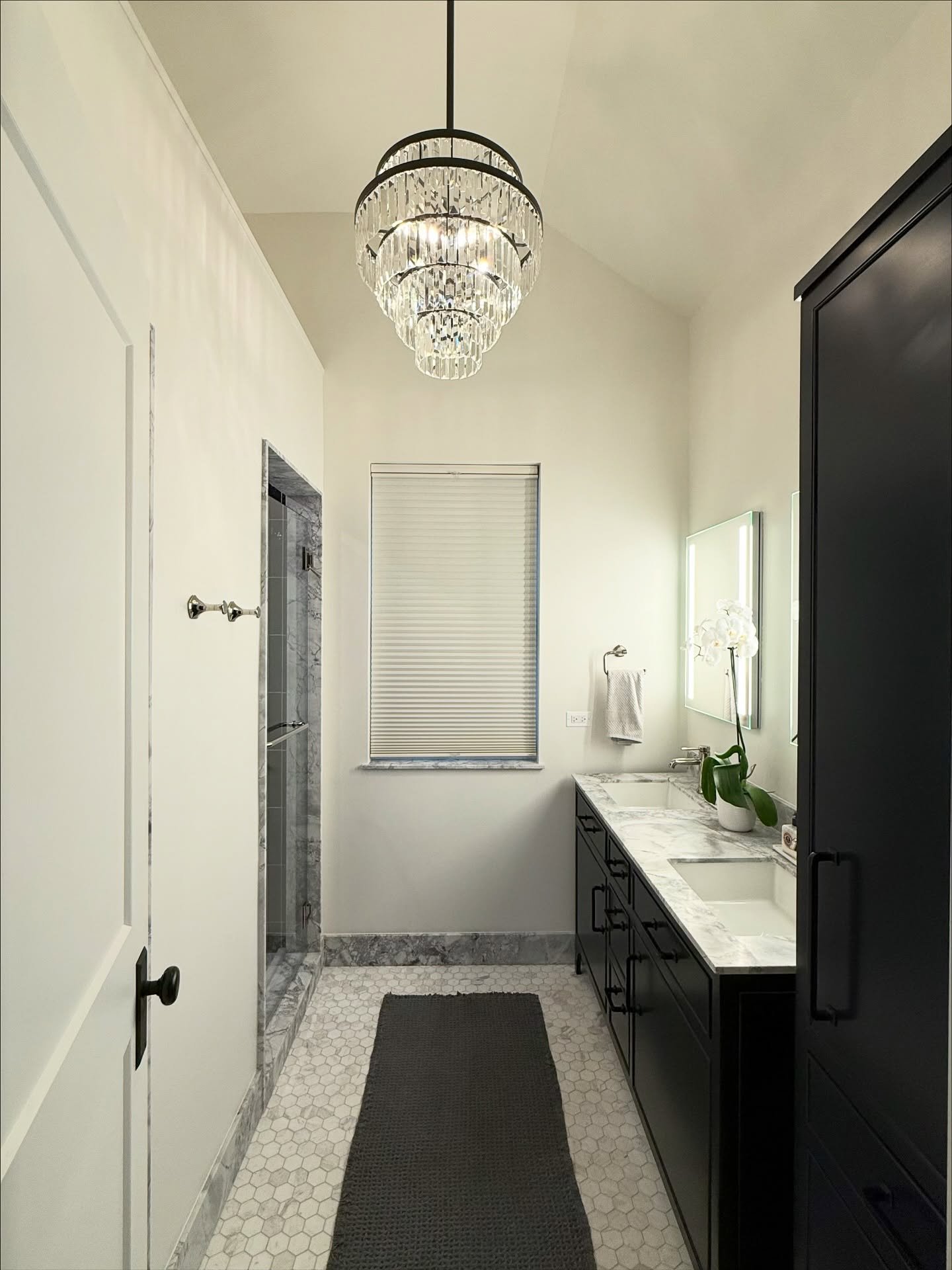 What was once an oversized closet has been thoughtfully transformed into a luxurious primary ensuite bathroom, bringing modern comfort to an older home. 

To enhance the sense of space, attic square footage was captured, allowing for vaulted ceilings