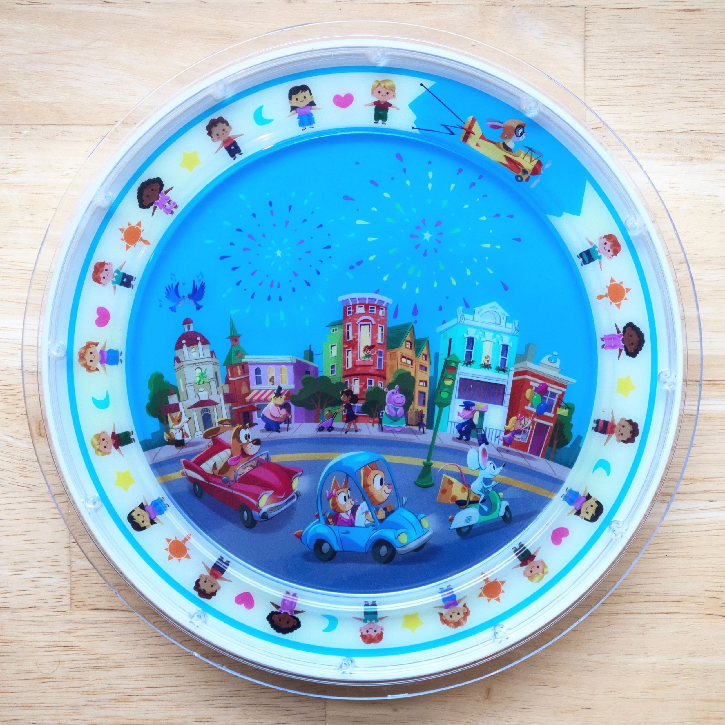 Colorful Disney-themed plate with characters, fireworks, and a cityscape design.