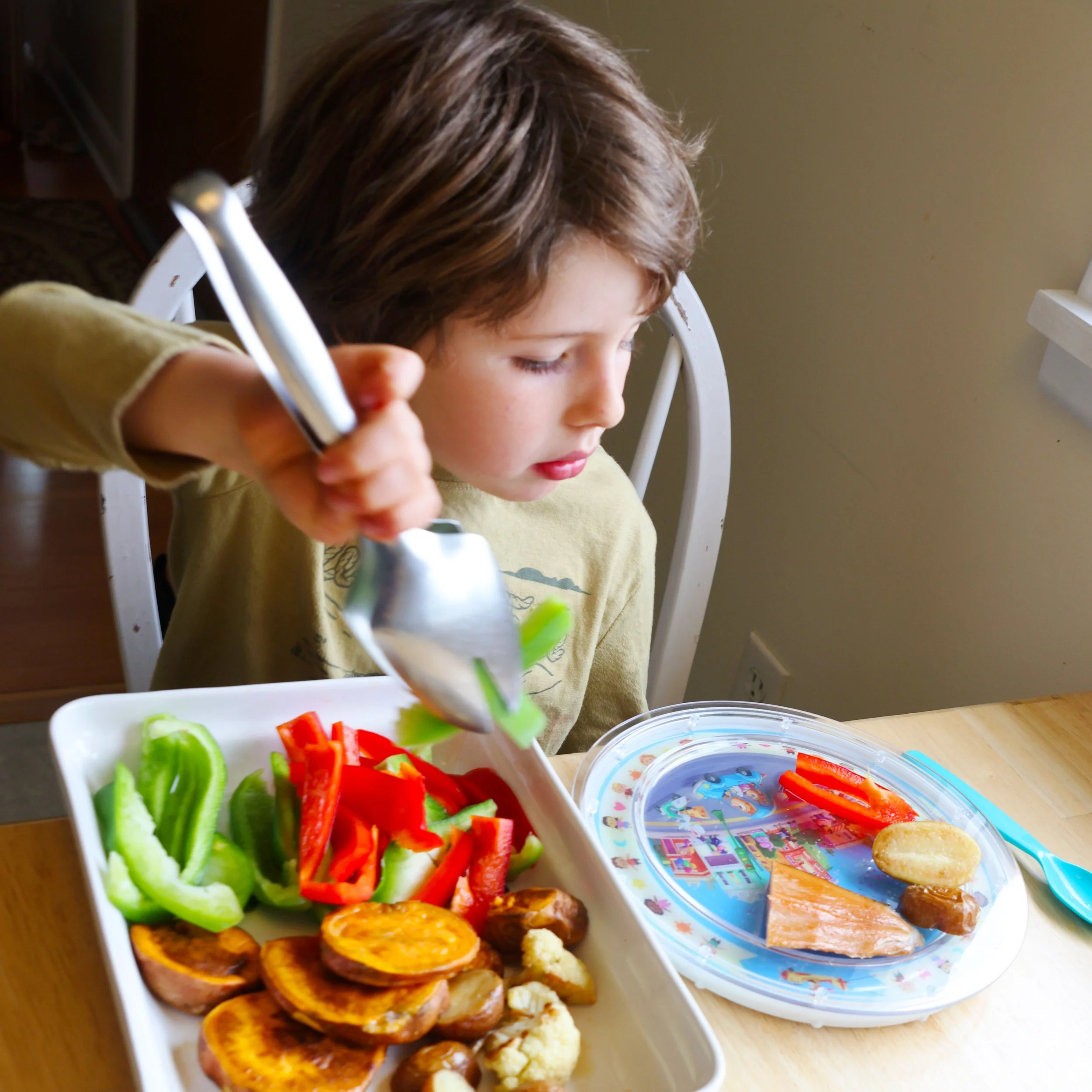 Kid serving their own food on their light up plate