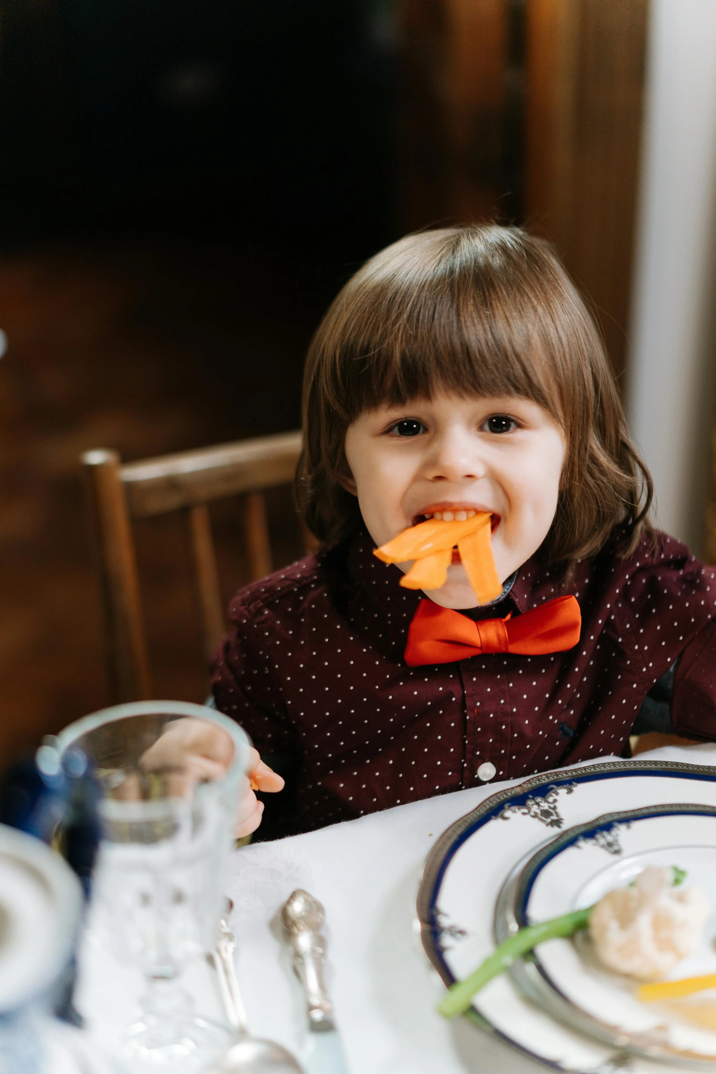 Kid eating carrots playing with their food