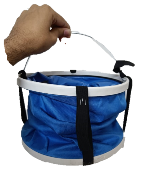 Hand holding a collapsible blue and white fishing bucket with a black strap