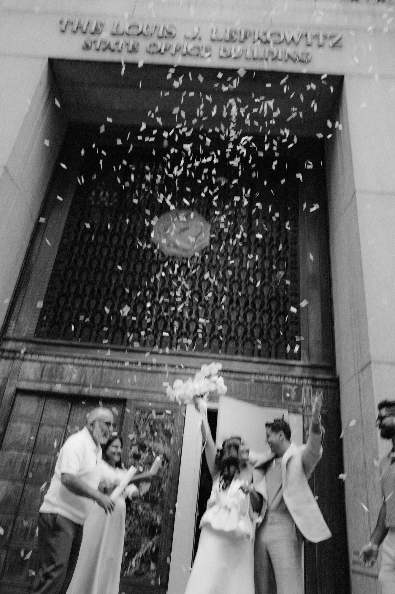 KC-140-couple-celebrating-with-confetti-outside-city-hall-elopement-nyc-jenny-fu.jpg