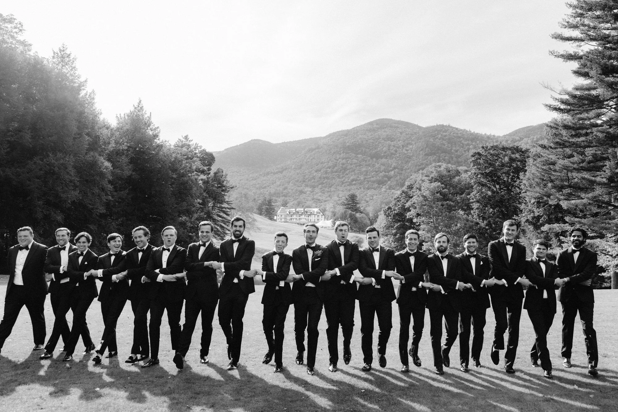 Groom in Tom Ford tuxedo with groomsmen lined up at The Ausable Club in the Adirondack Mountains