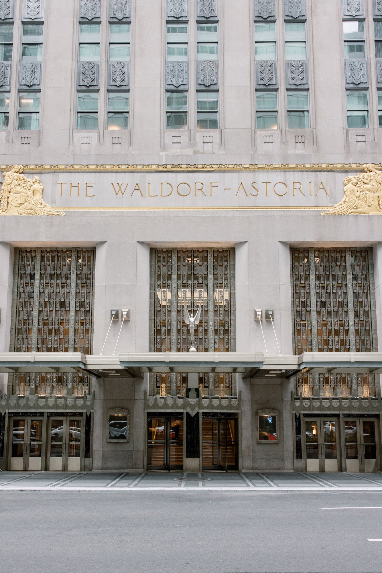 Art Deco facade and gilded entrance of the Waldorf Astoria on Park Avenue, New York City, photographed by Jenny Fu.