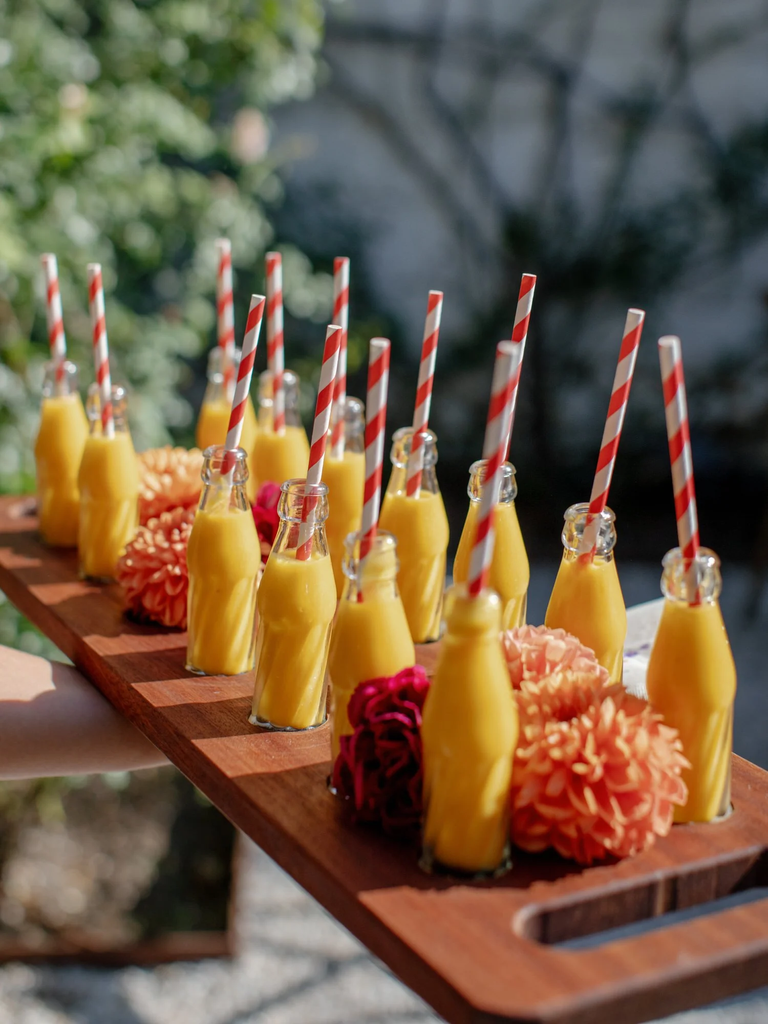 Mango welcome shots in small bottles with striped paper straws at Valley Rock Inn in Sloatsburg, photographed by Jenny Fu.